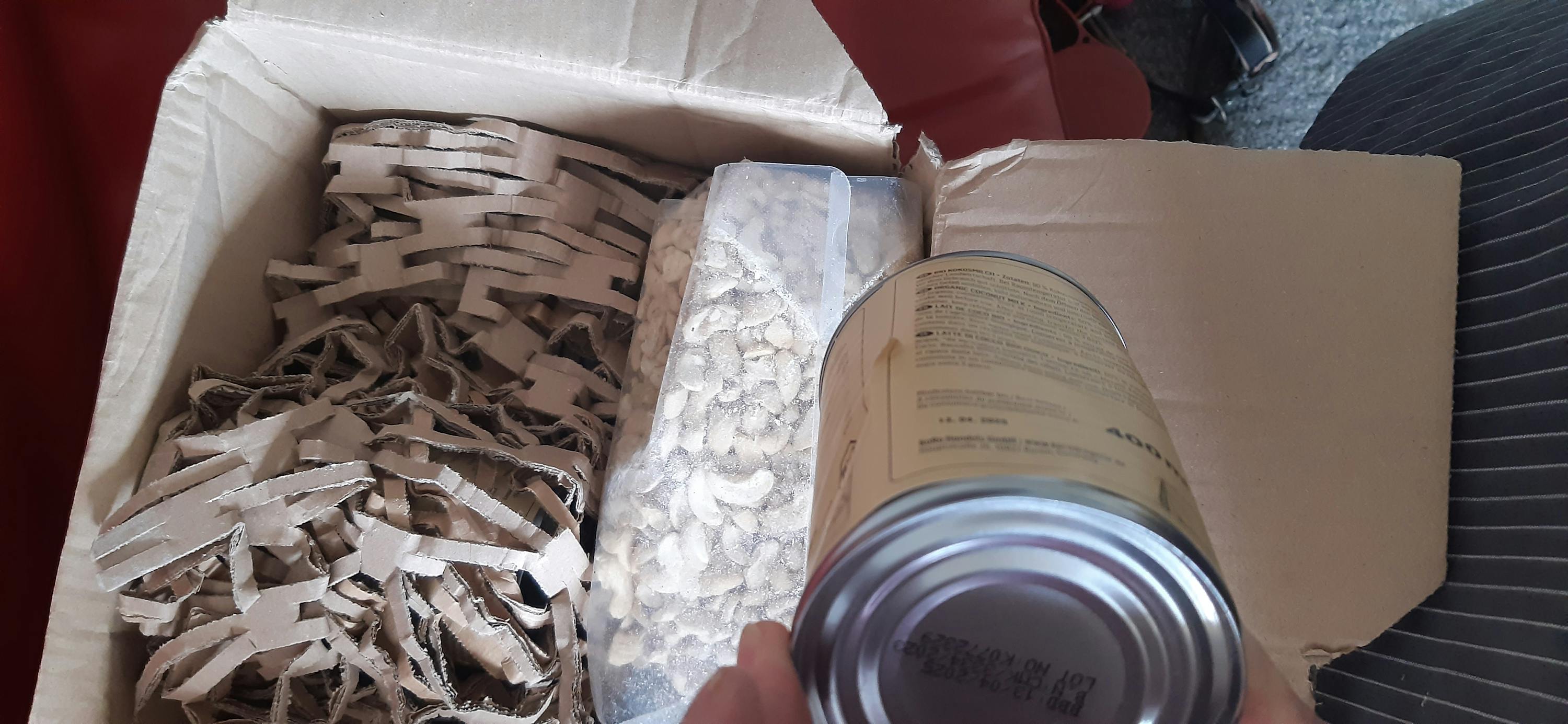 a person is opening a can of beans that has a date of 09.12.2021 on it