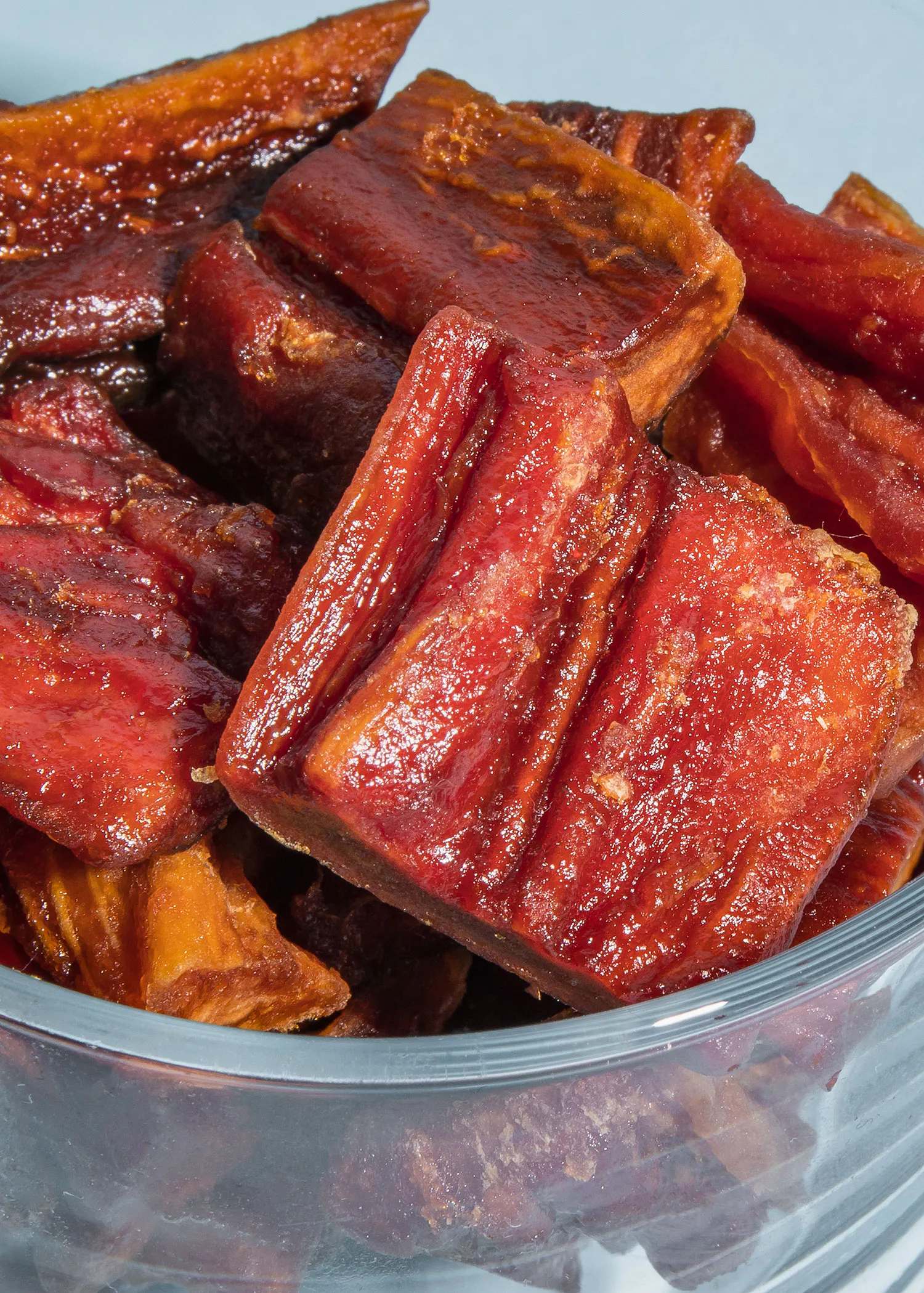 a glass bowl filled with slices of red meat