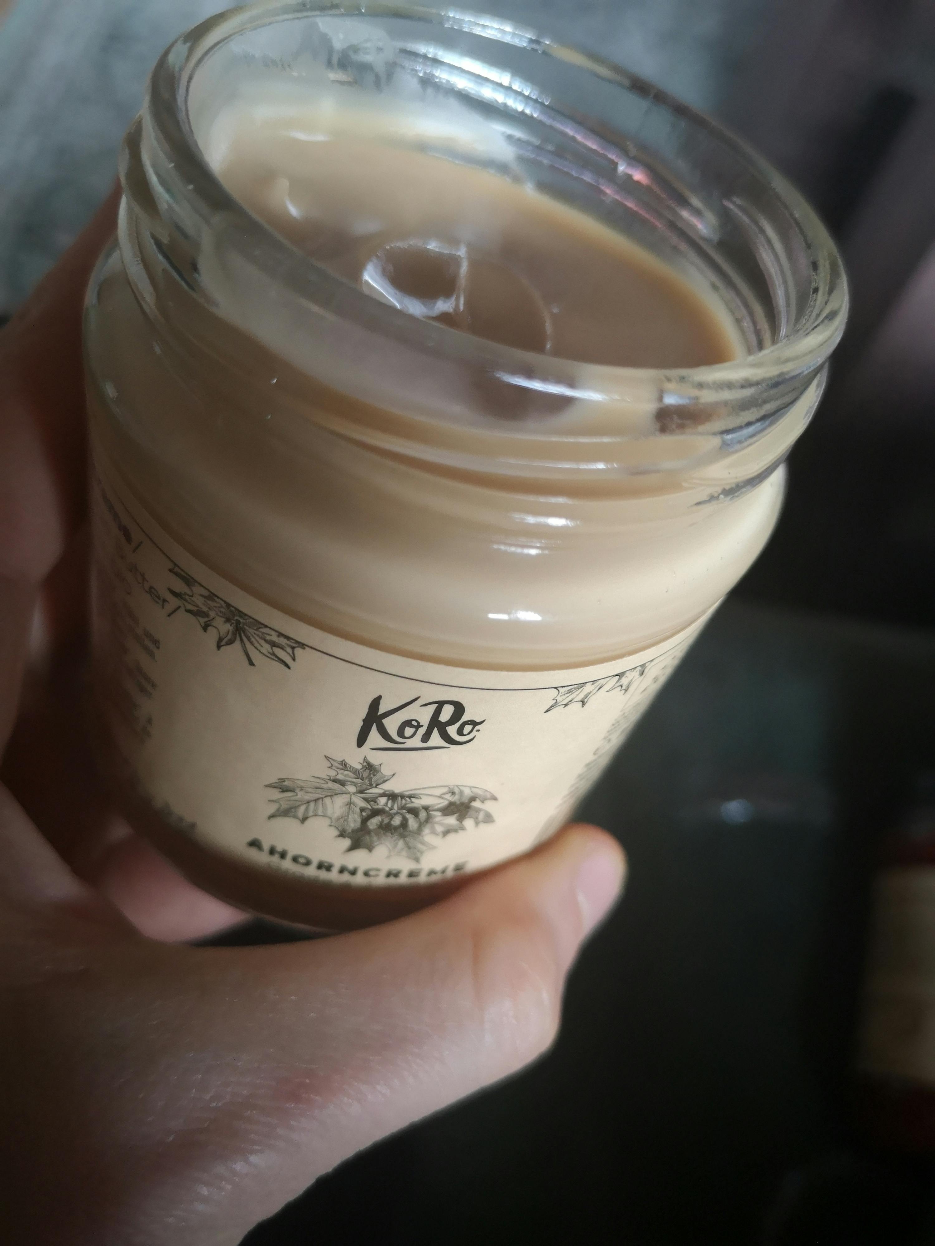 a person is holding a jar that says koro on it