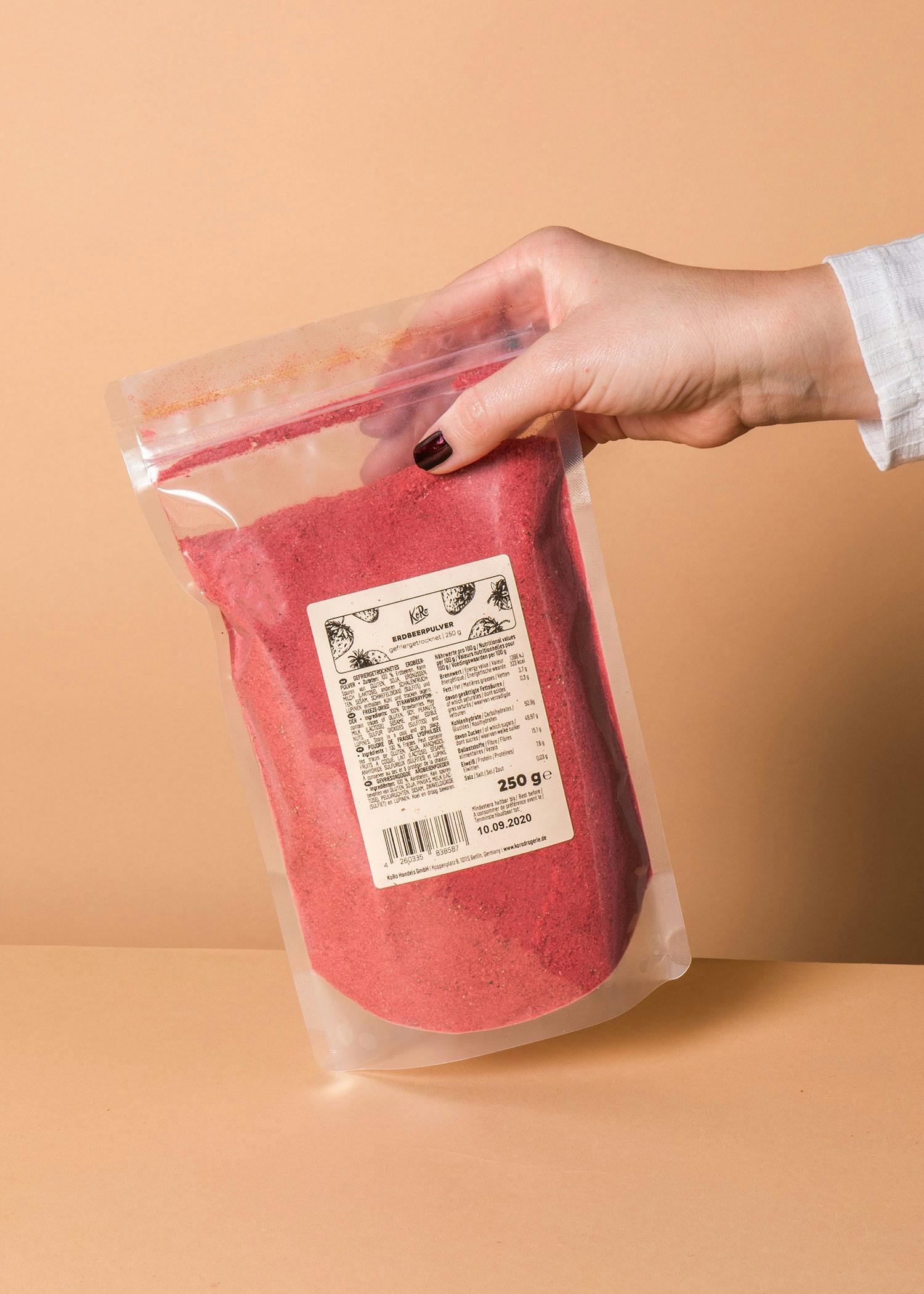 a person is holding a bag of red powder