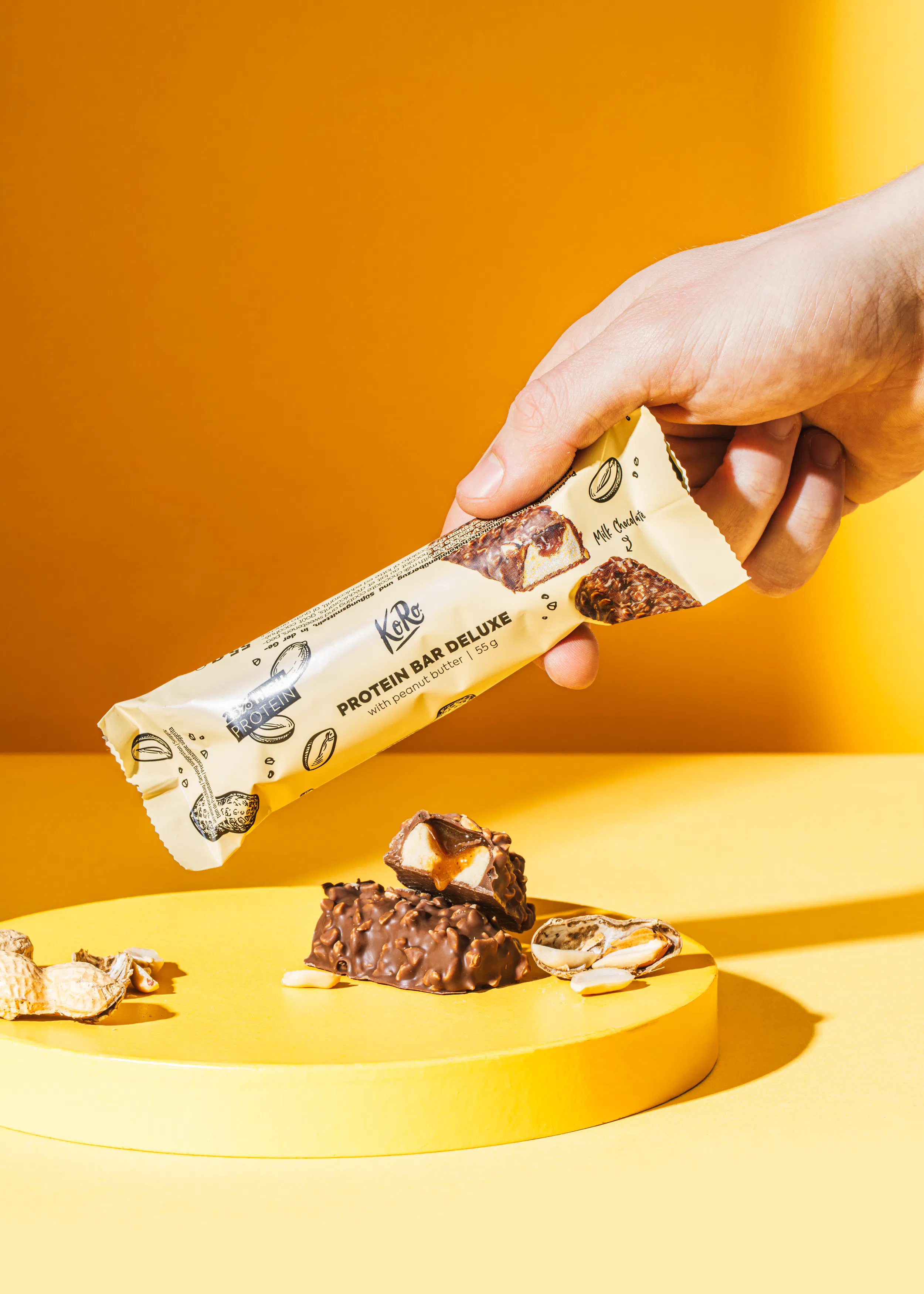 a person is holding a protein bar deluxe in their hand