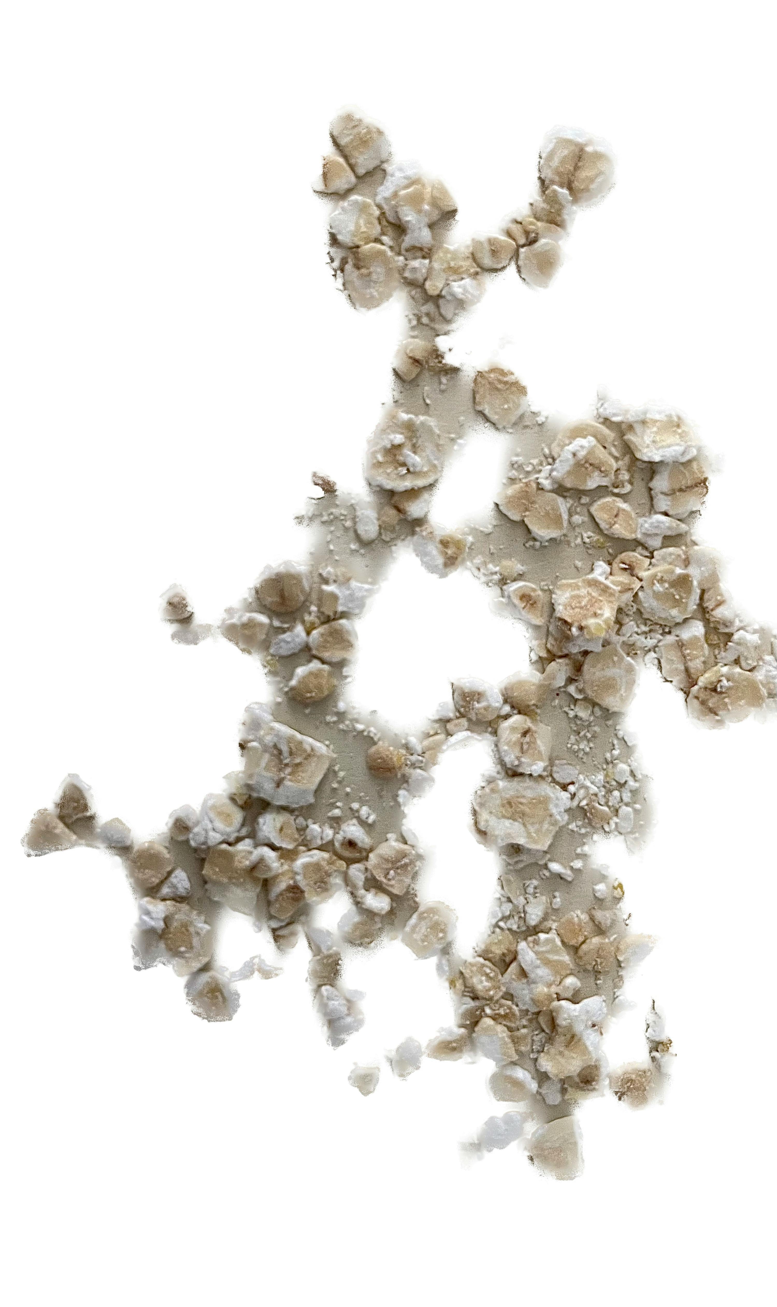 a pile of rocks on a white surface with a hole in the middle