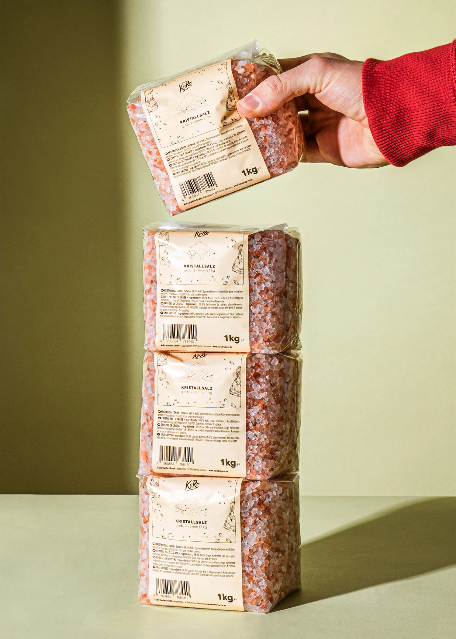a person is holding a bag of 1kg salt