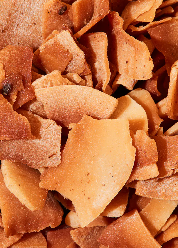 a close up of a pile of fried coconut chips
