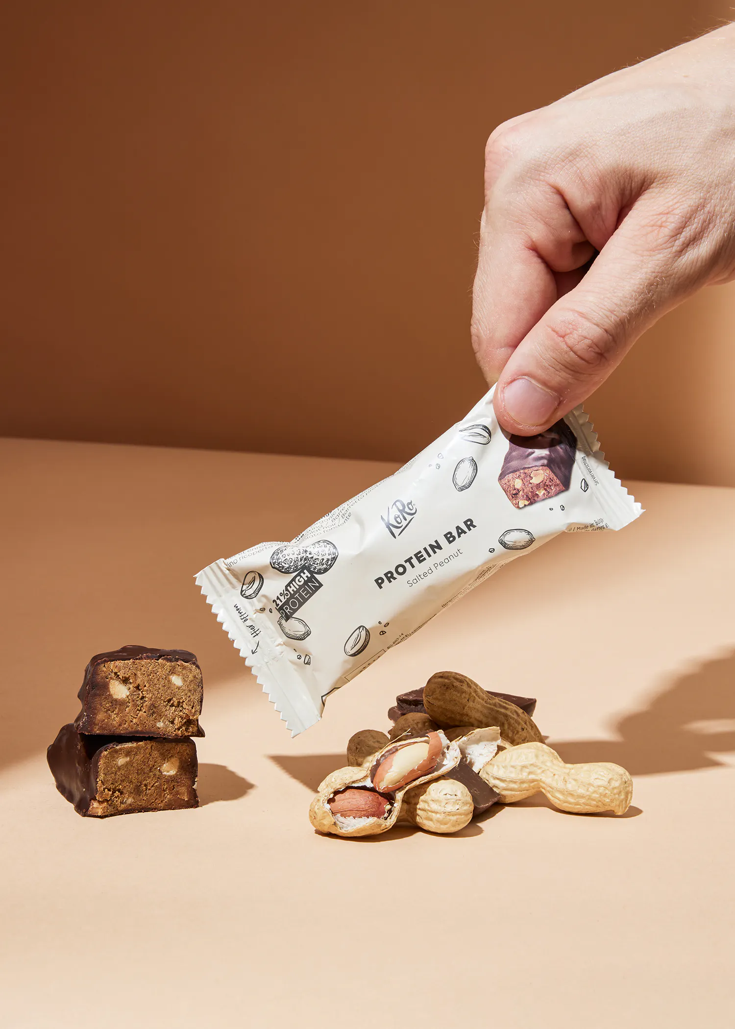 a person is holding a kale protein bar in their hand