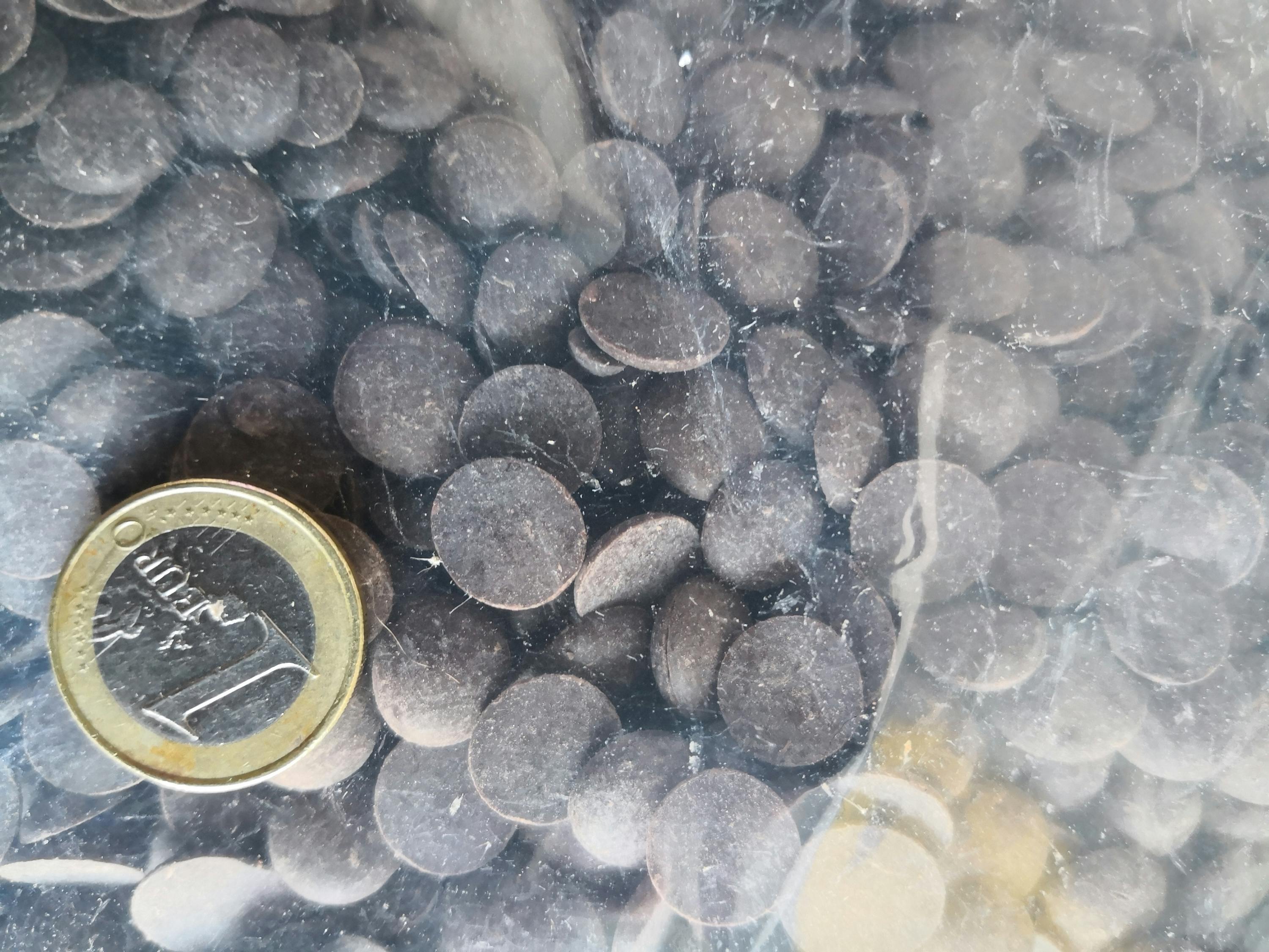 a 1 euro coin is next to a pile of chocolate chips