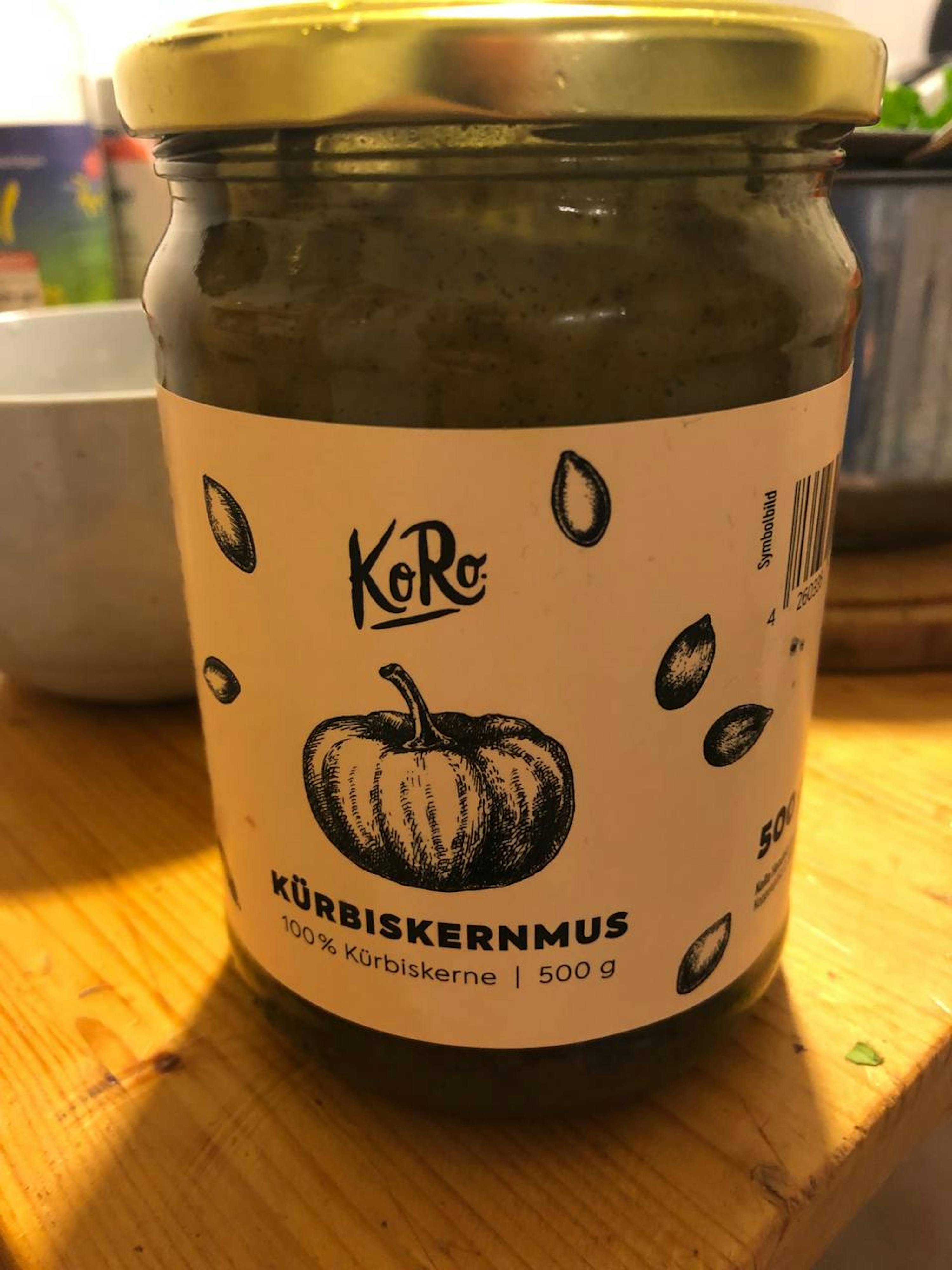 a jar of korc kurbiskernmus sits on a wooden table