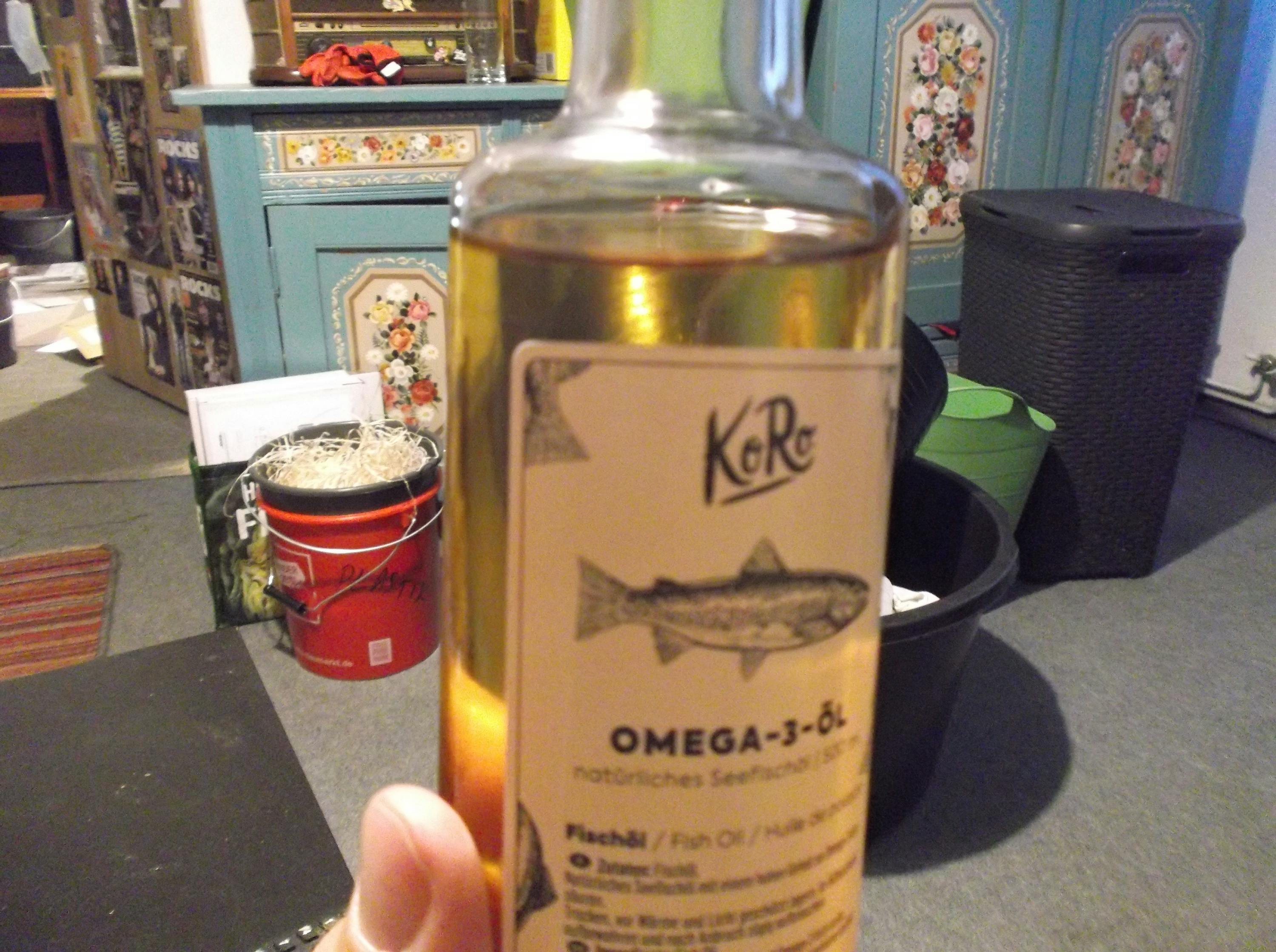 a person is holding a bottle of omega-3 oil