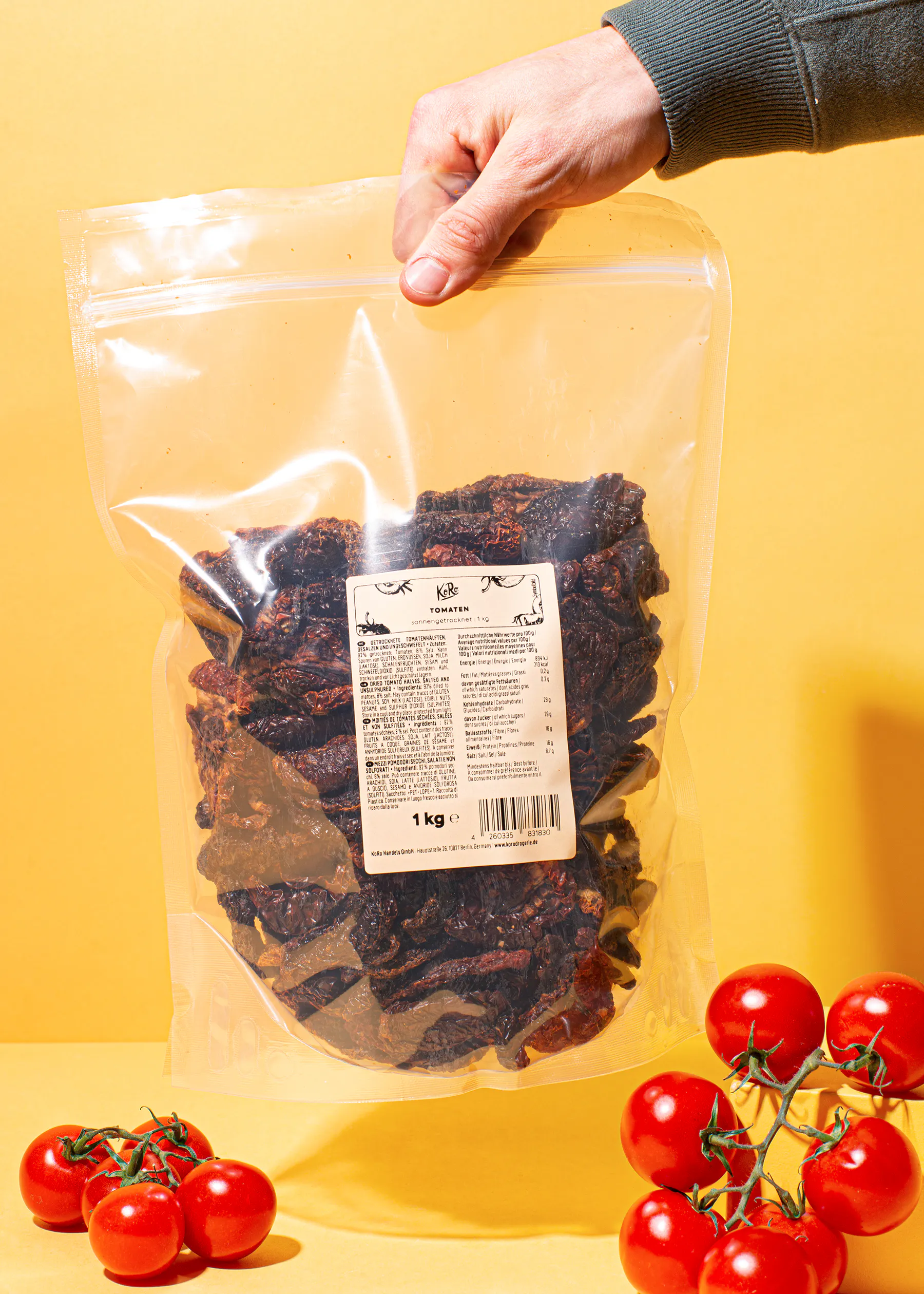 a person is holding a bag of dried tomatoes with a label that says 1 kg