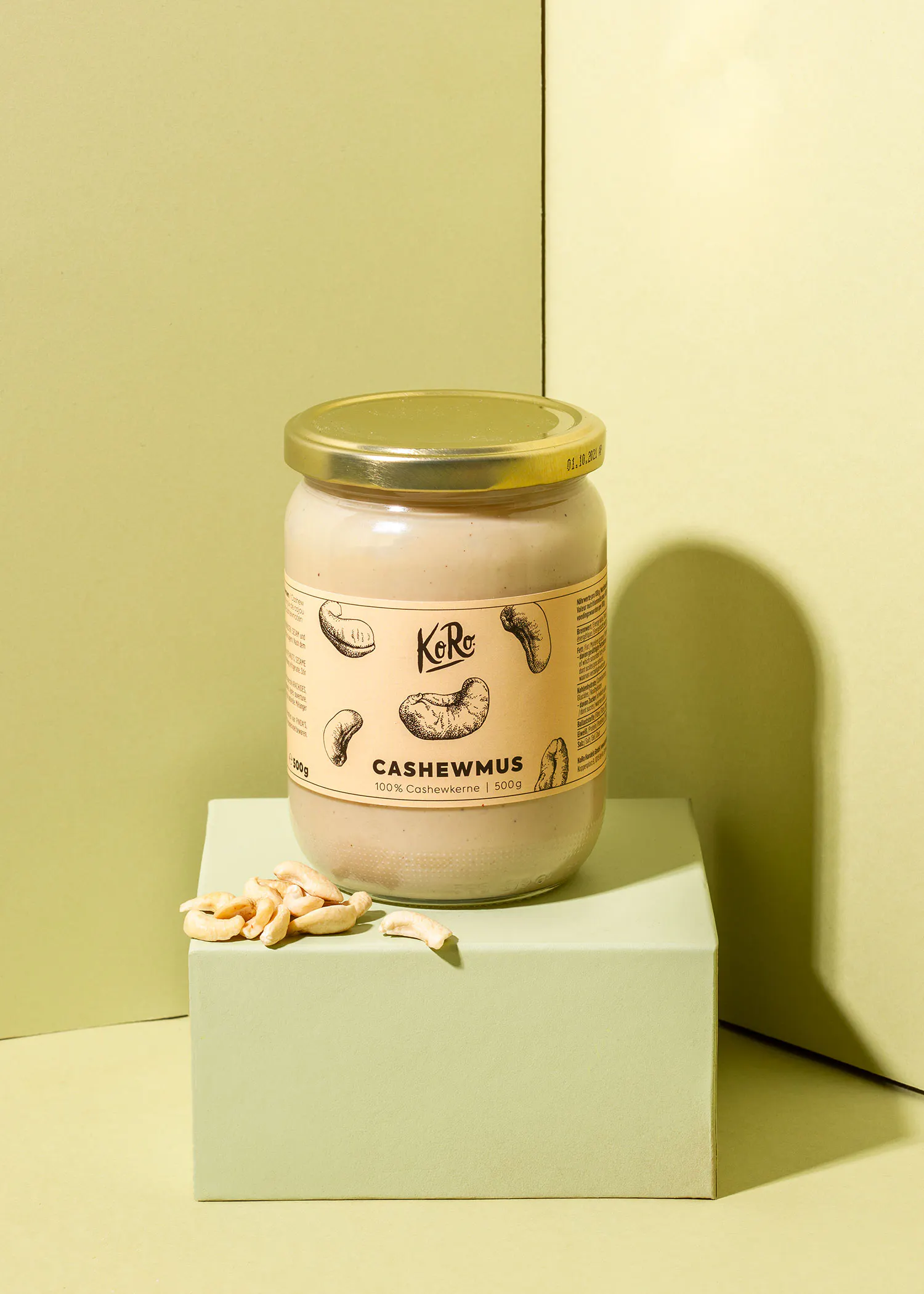 a jar of cashewmus sits on a green cube