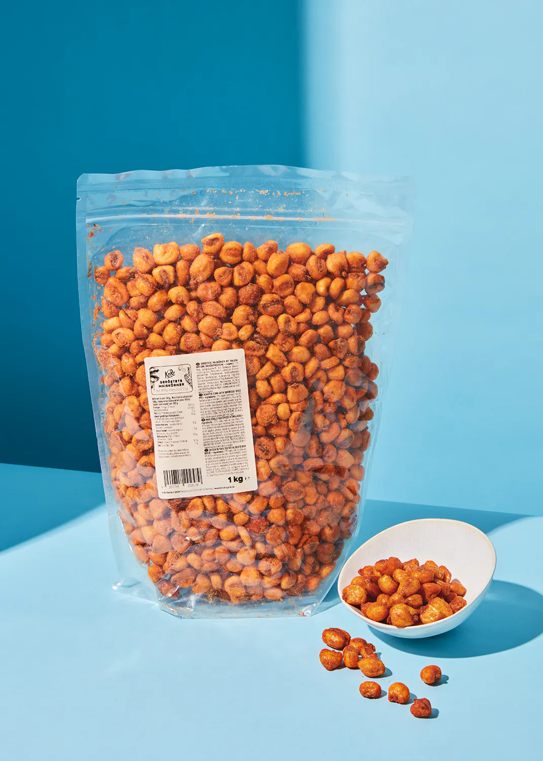 a bag of corn is next to a bowl of corn