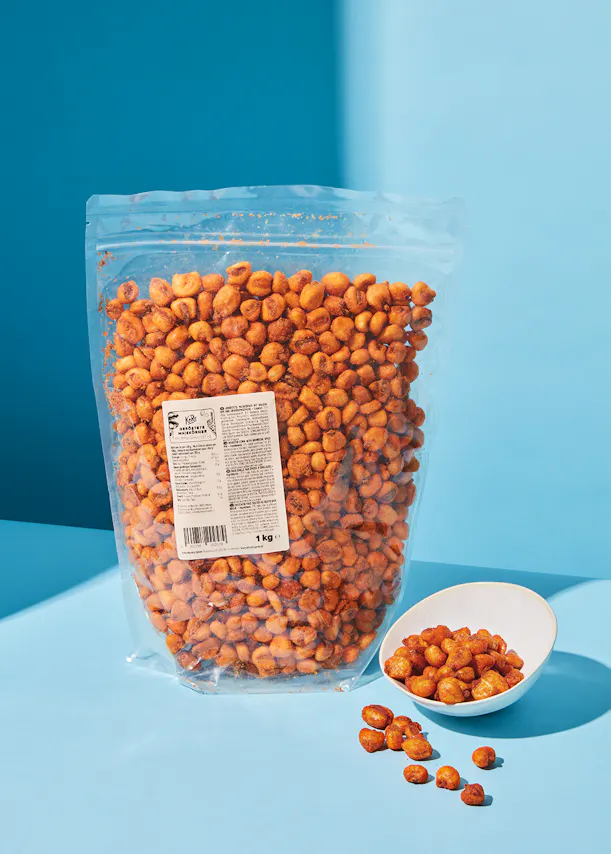 a bag of corn is next to a bowl of corn