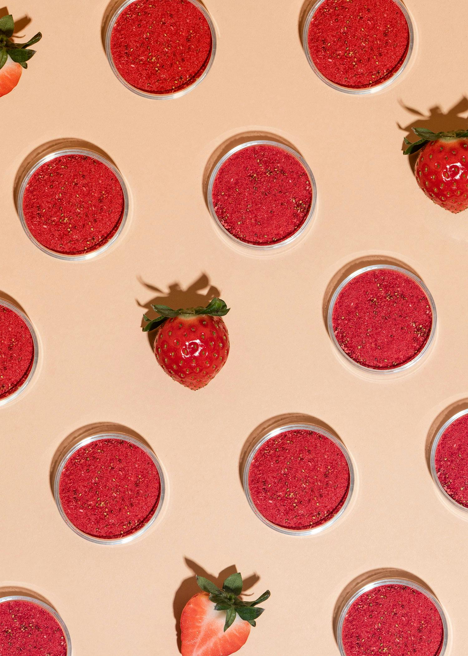 a strawberry sits in the middle of a circle of strawberries