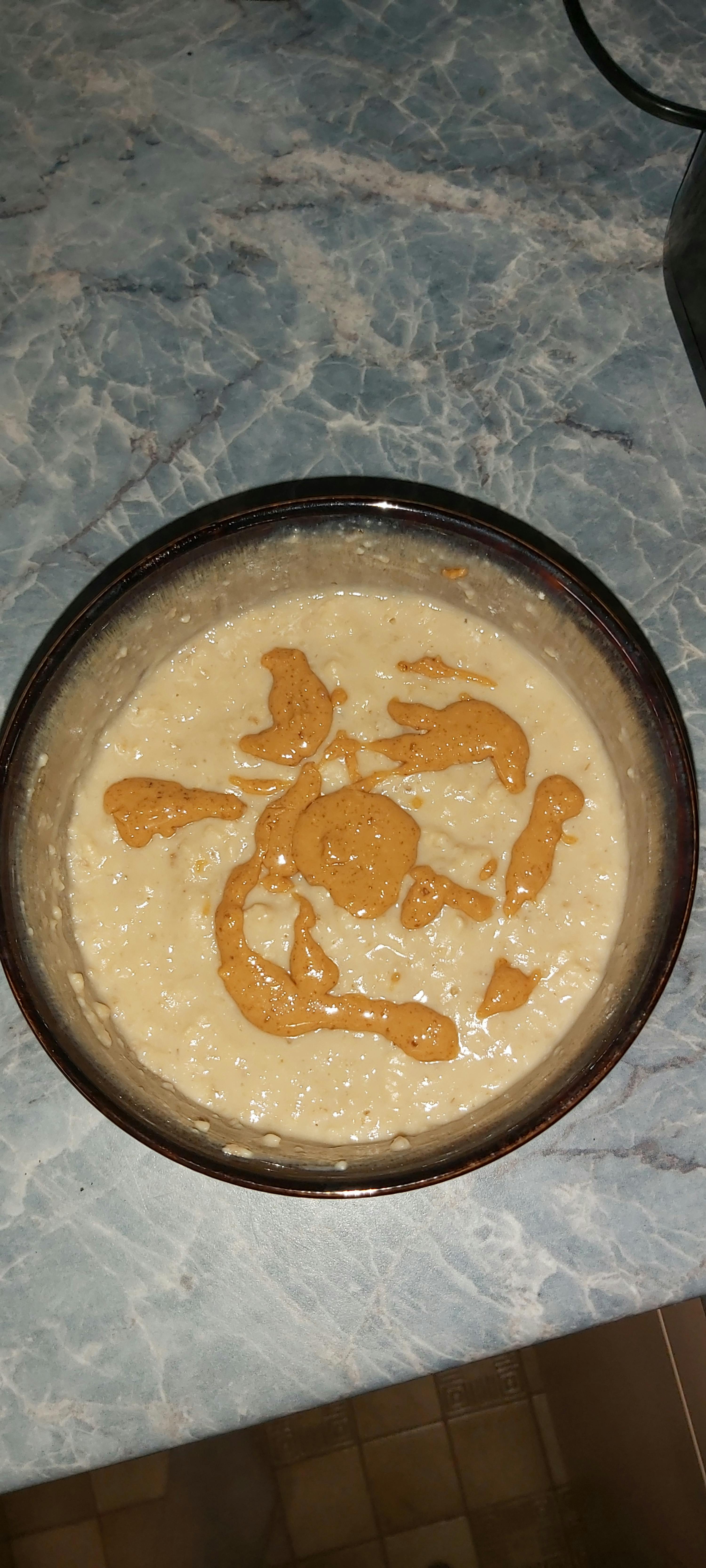 a bowl of food with peanut butter on top of it