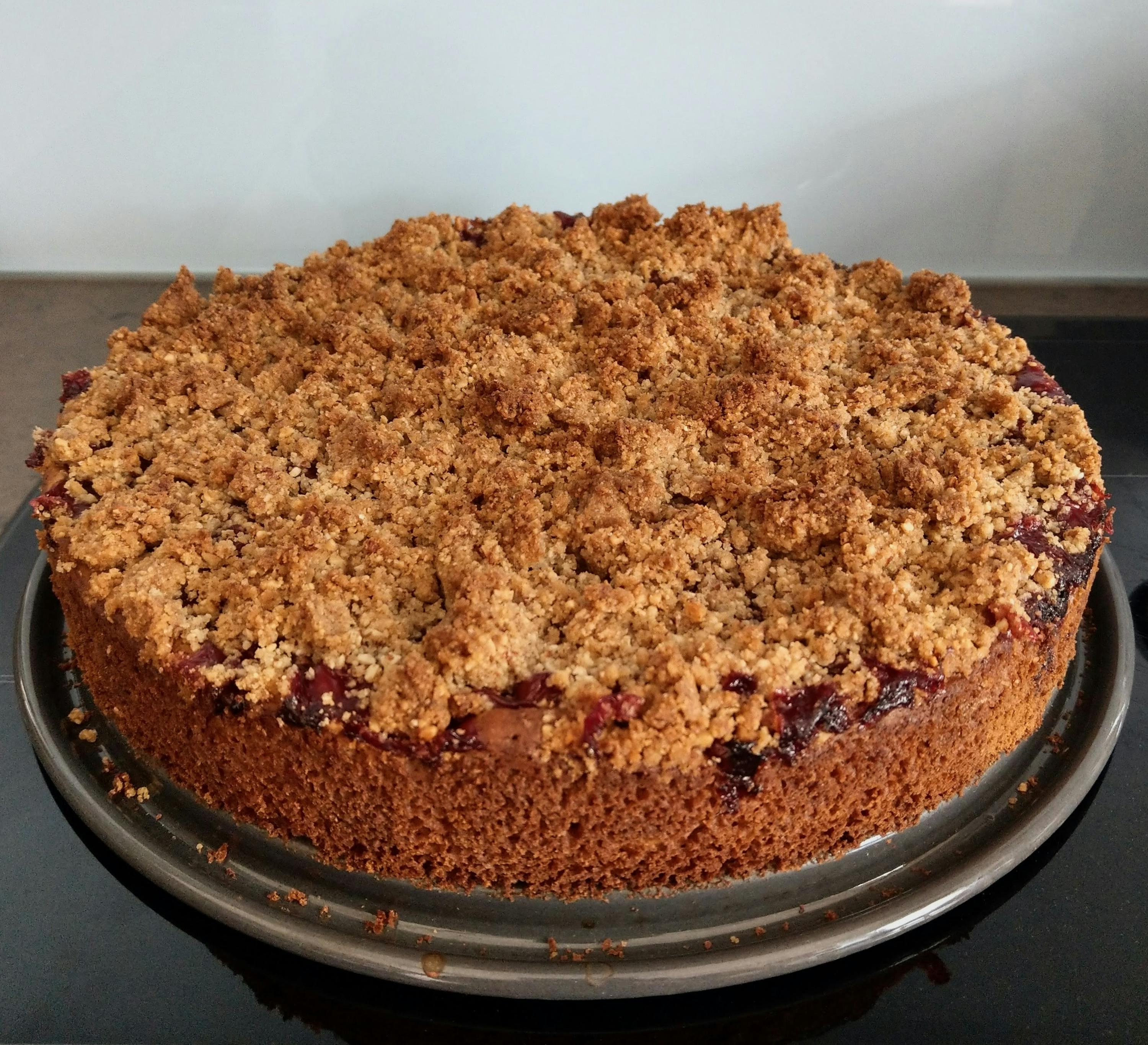 a cake with a crumb topping is on a plate