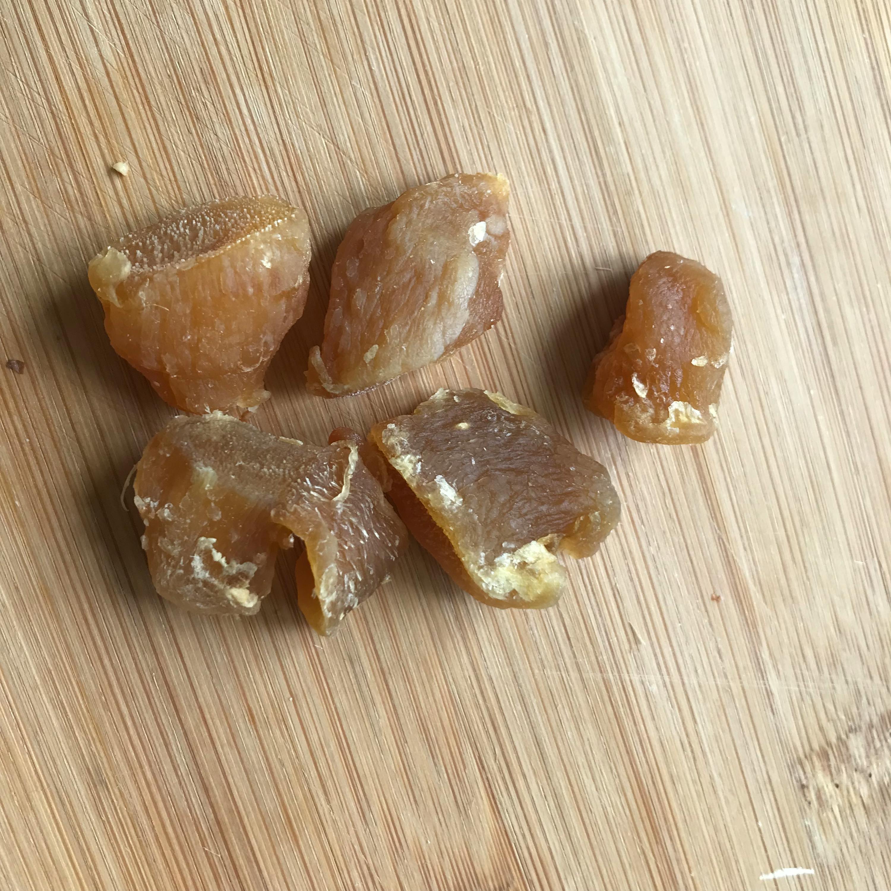 a wooden cutting board with a few pieces of food on it