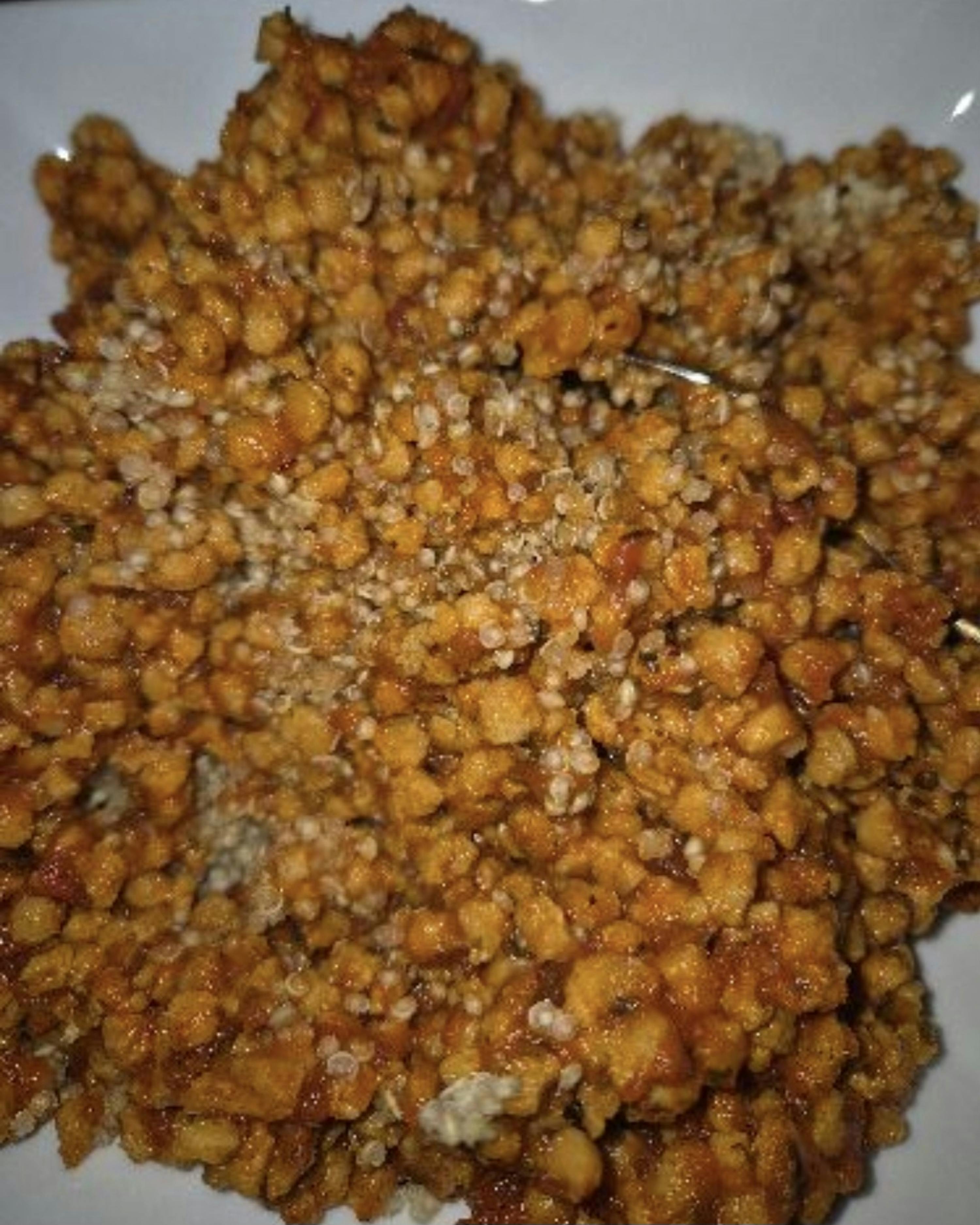 a close up of a plate of food with beans and sauce