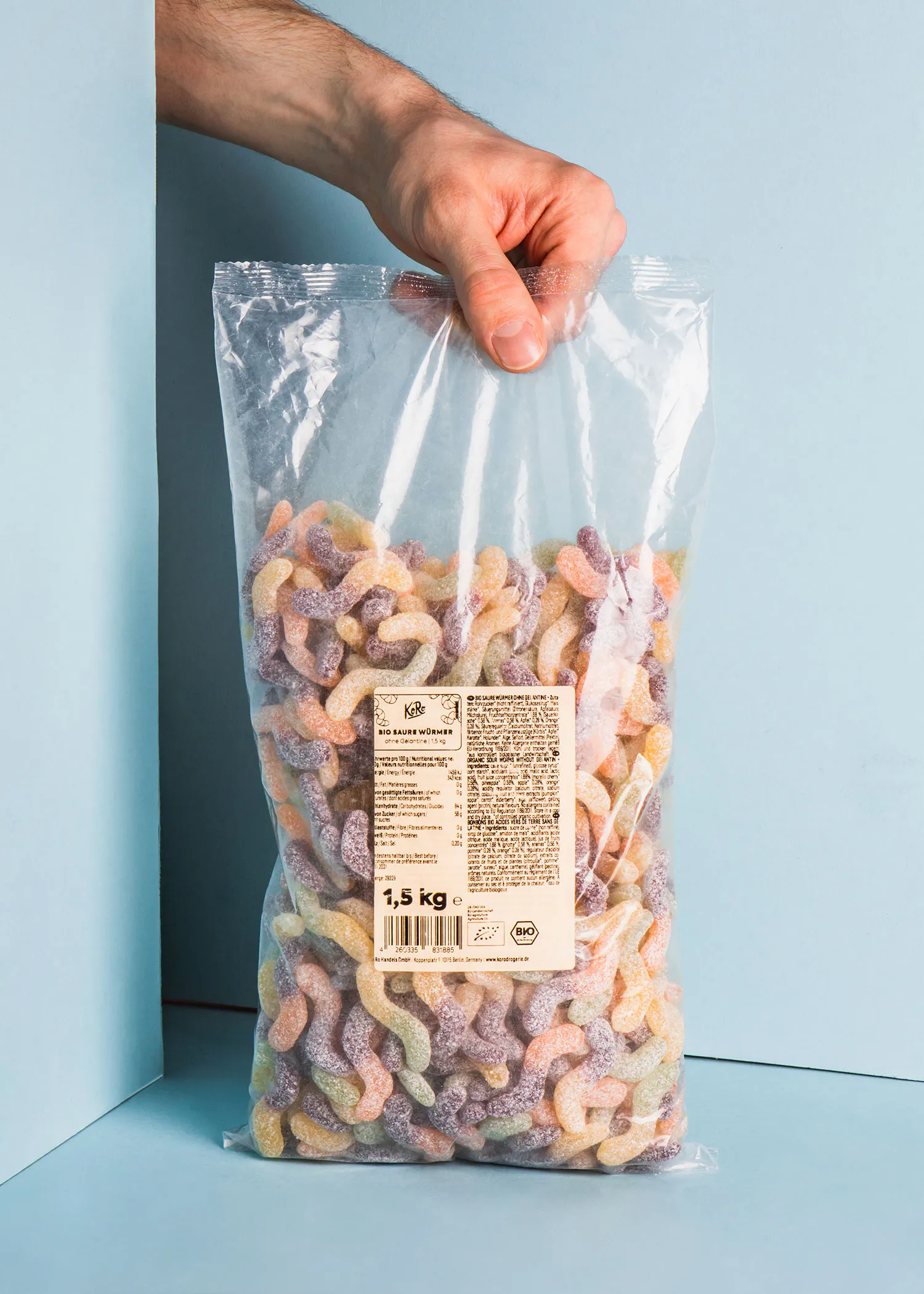 a person is holding a bag of candy that says 1,5 kg