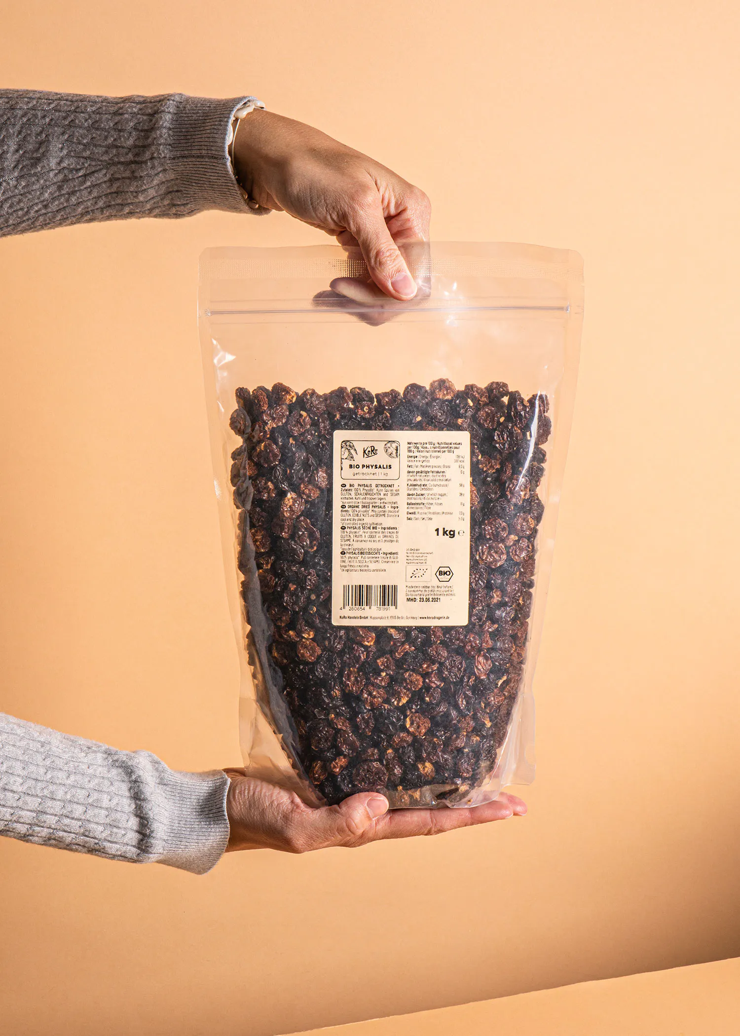 a person is holding a bag of bio pistachios in their hands