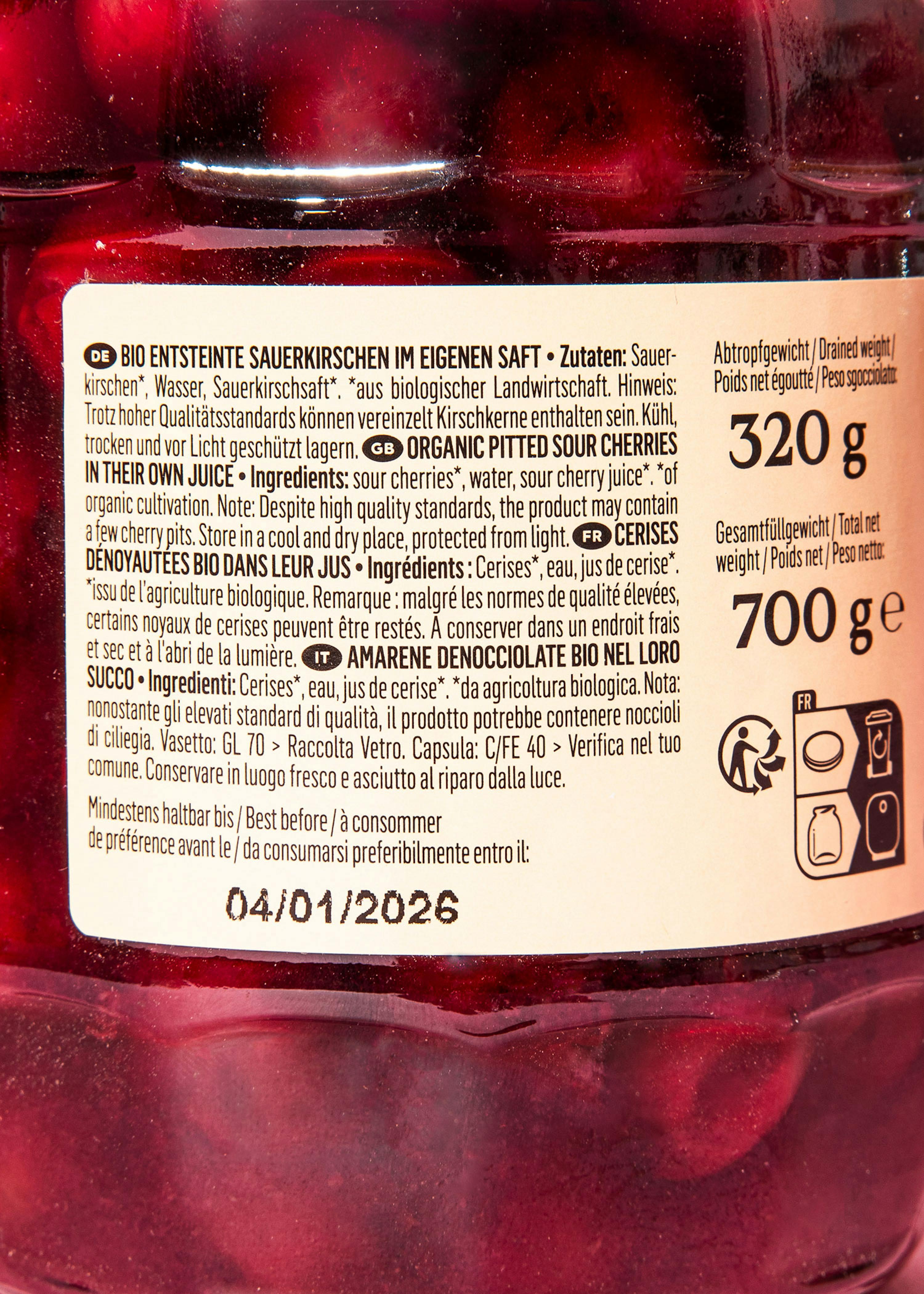 a jar of cherries has a label that says 04/01/2026 on it