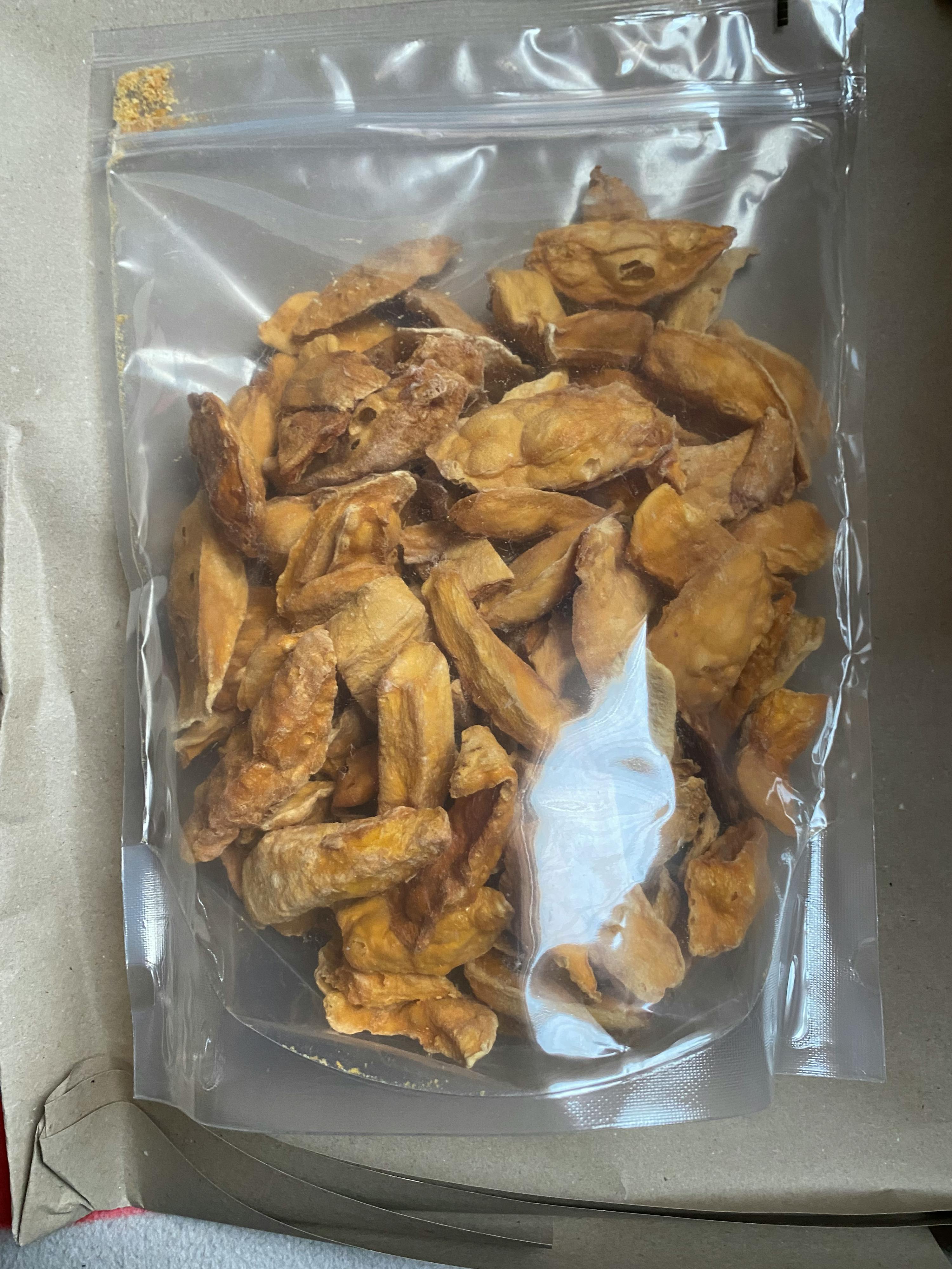 a clear plastic bag filled with pieces of fried food