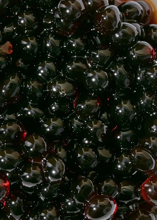 a close up of a pile of black beads with a red center