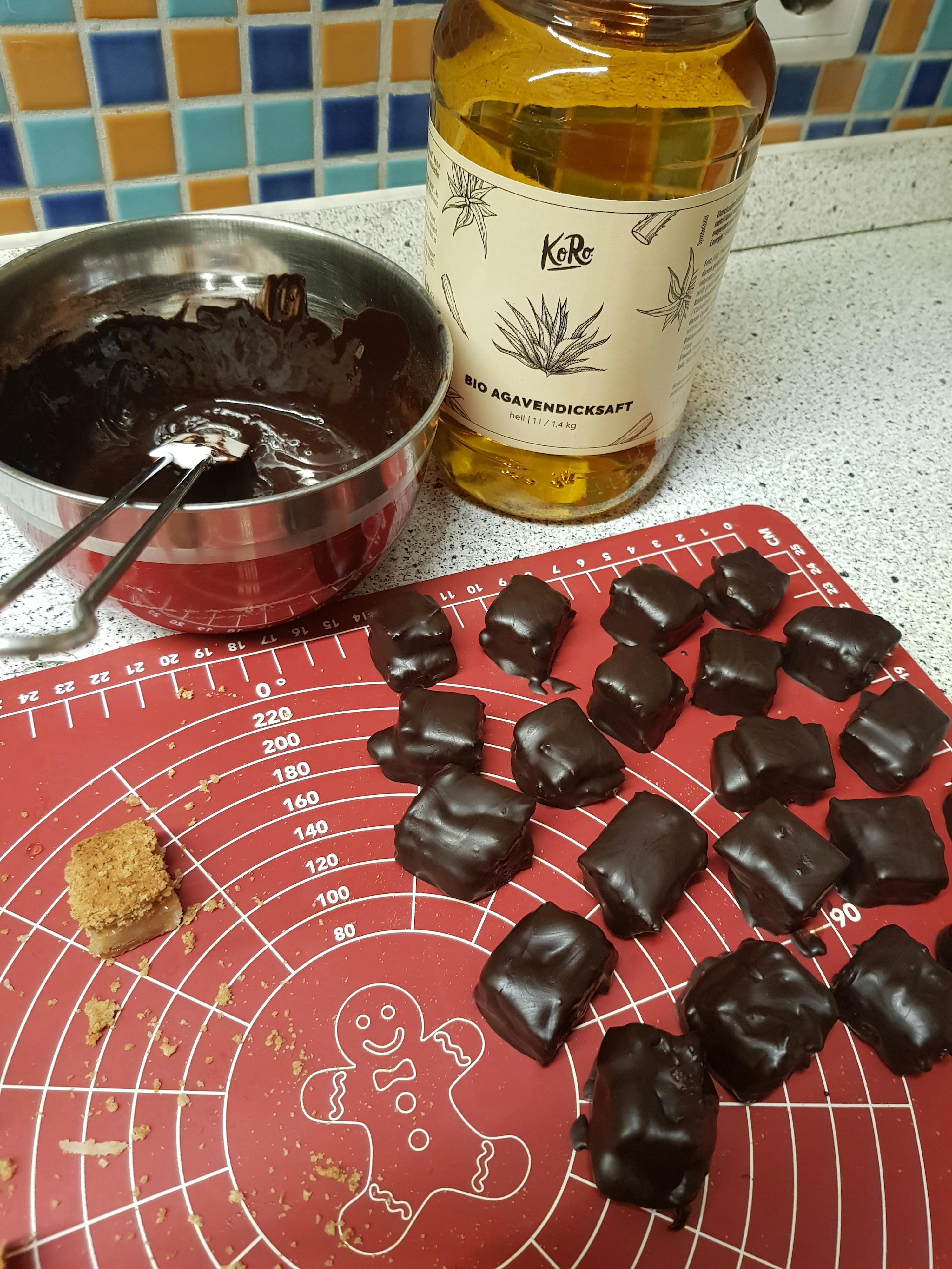 a gingerbread man is on a measuring mat next to a jar of honey