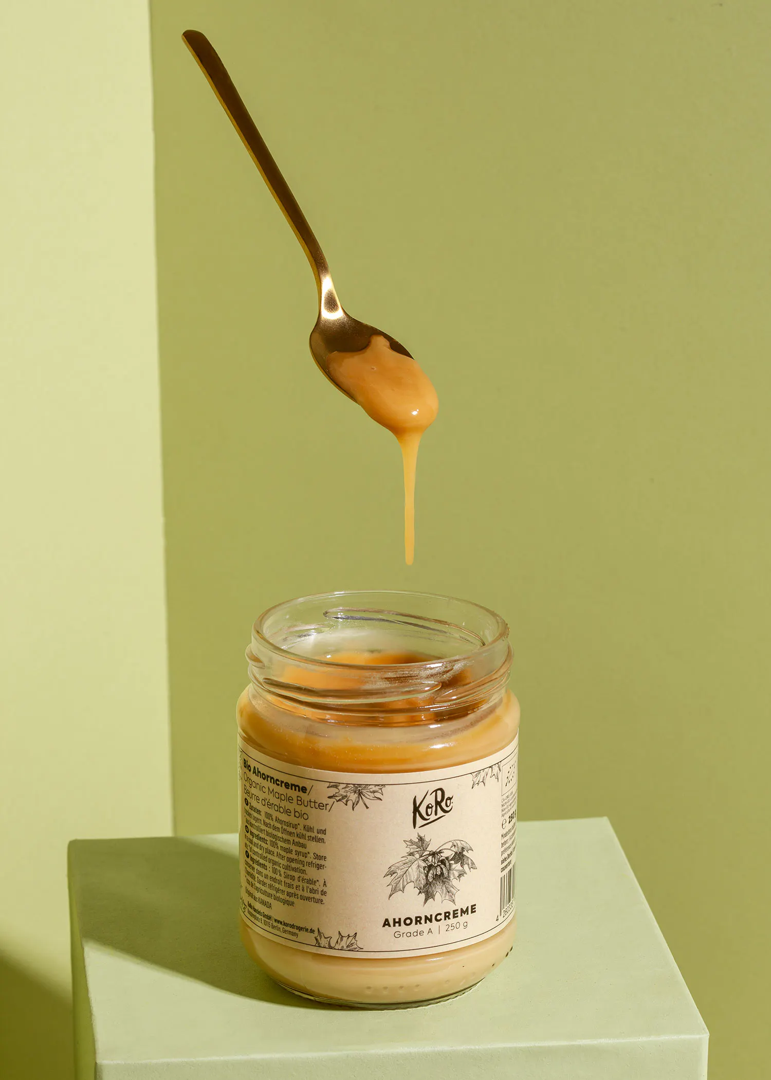 a jar of ahorncreme with a gold spoon in it