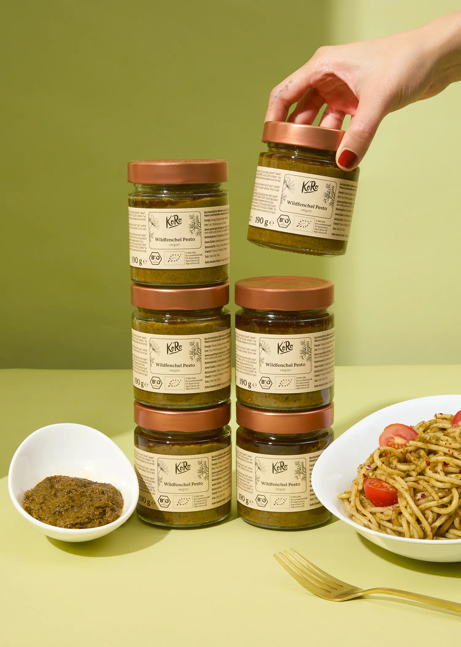 a person is holding a jar of wheat pesto