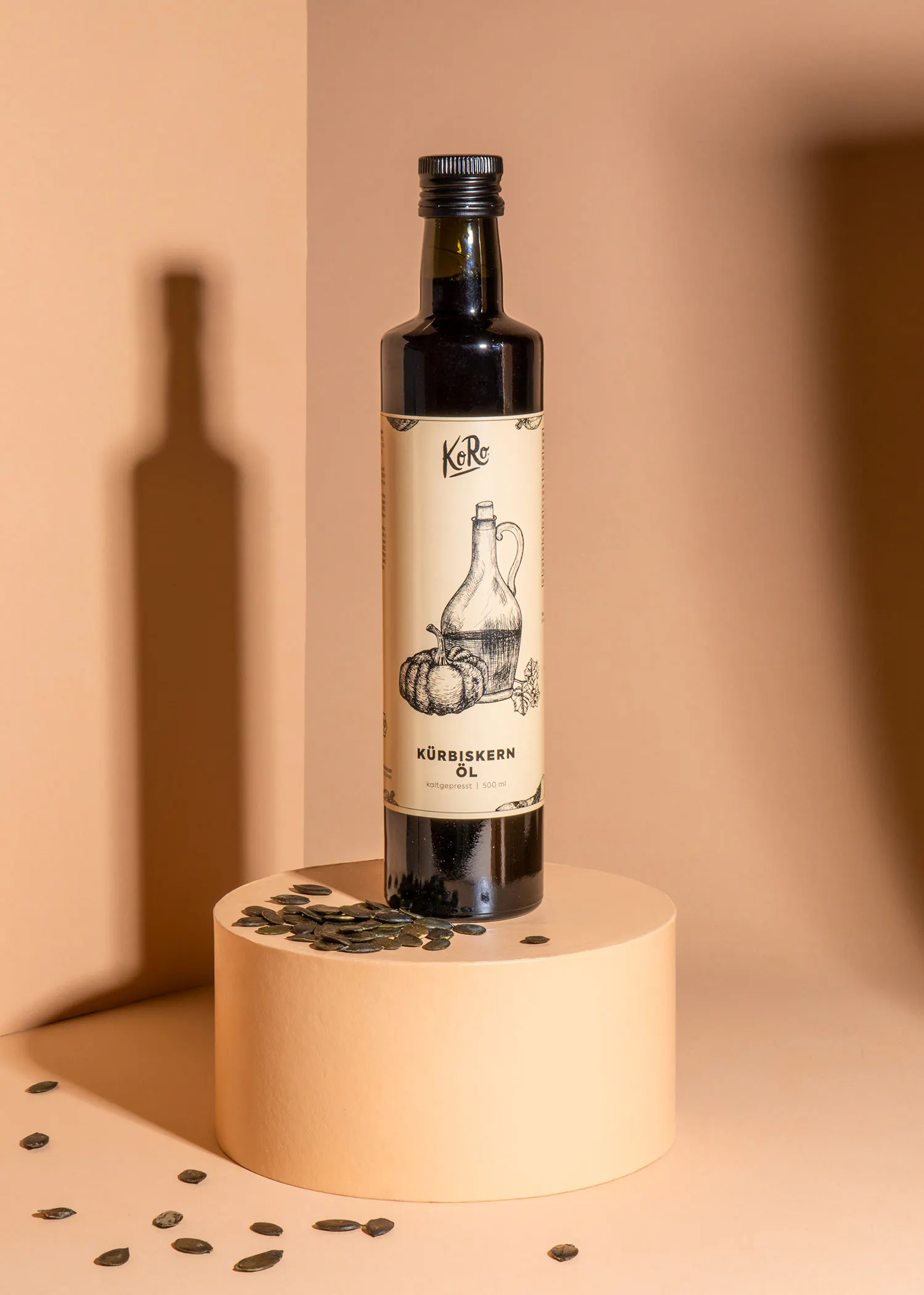 a bottle of kurbiskern oil sits on a pedestal