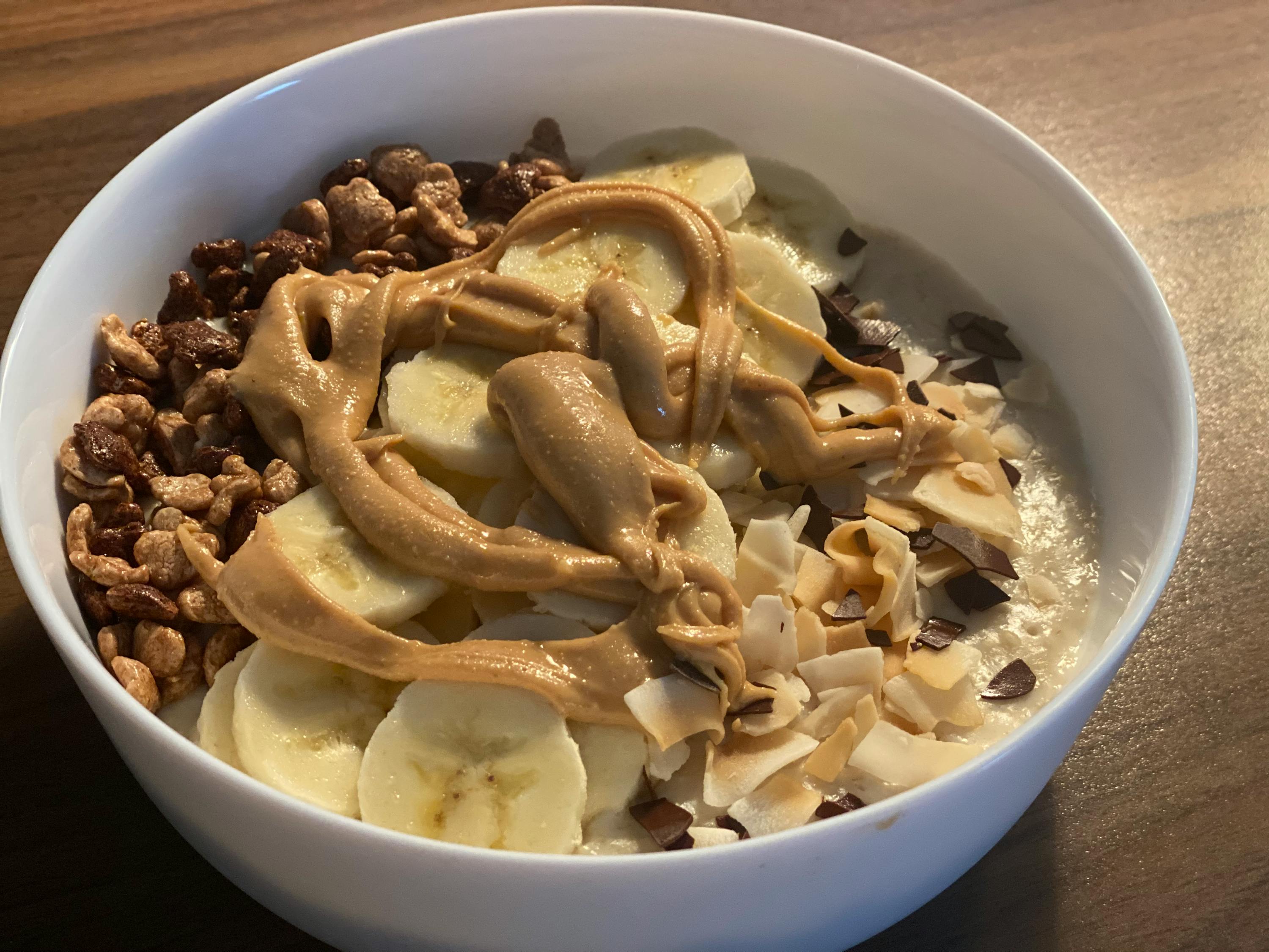 a bowl of food with bananas peanut butter and chocolate chips