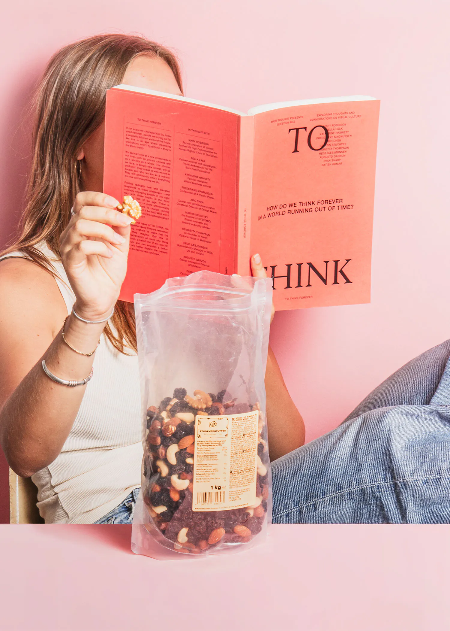 a woman is reading a book titled to hink
