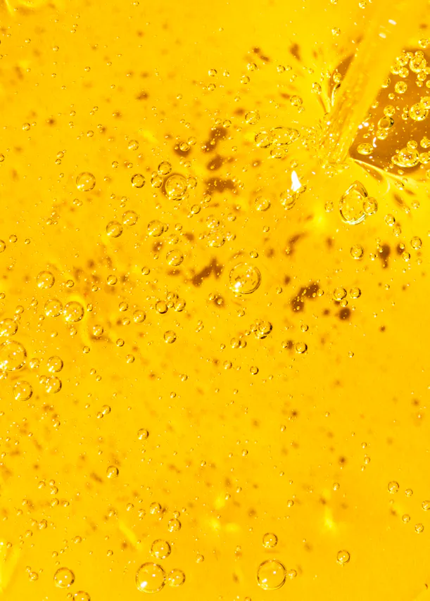 a close up of a yellow liquid with bubbles