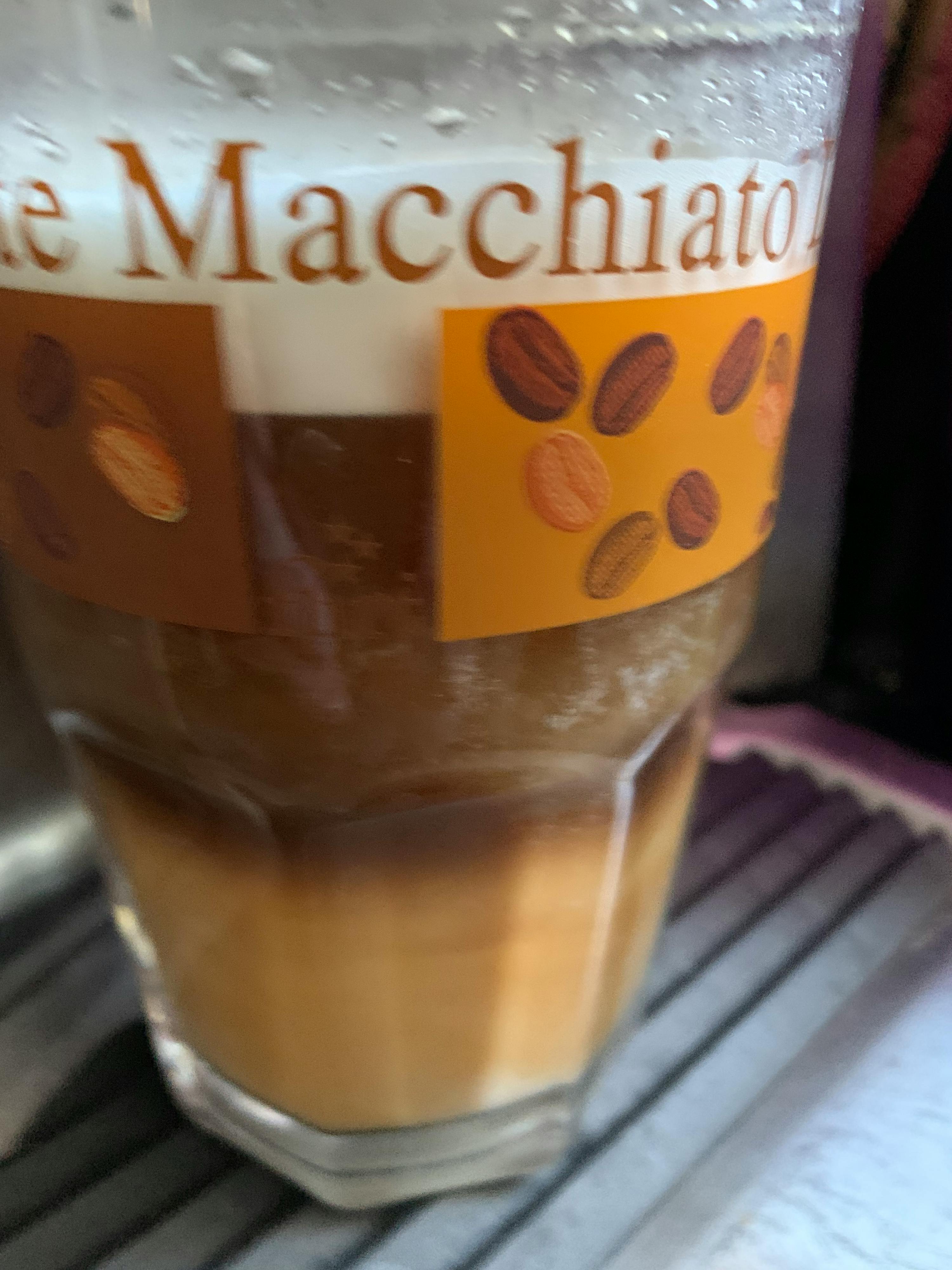 a glass with a label that says ' cafe macchiato ' on it