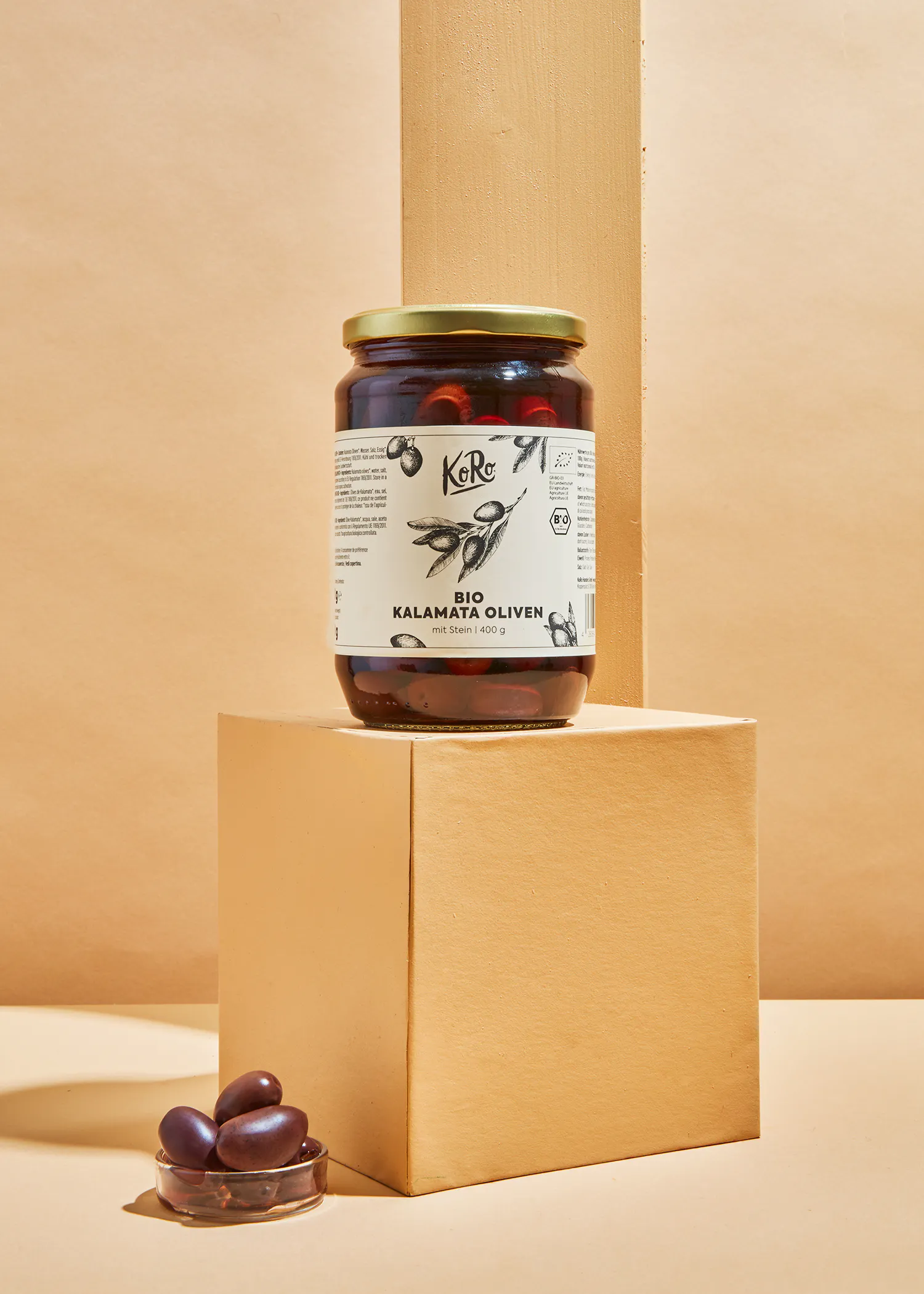 a jar of kalamata olives sits on a box