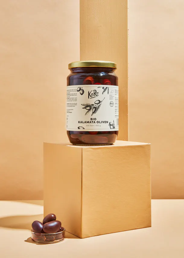 a jar of kalamata olives sits on a box