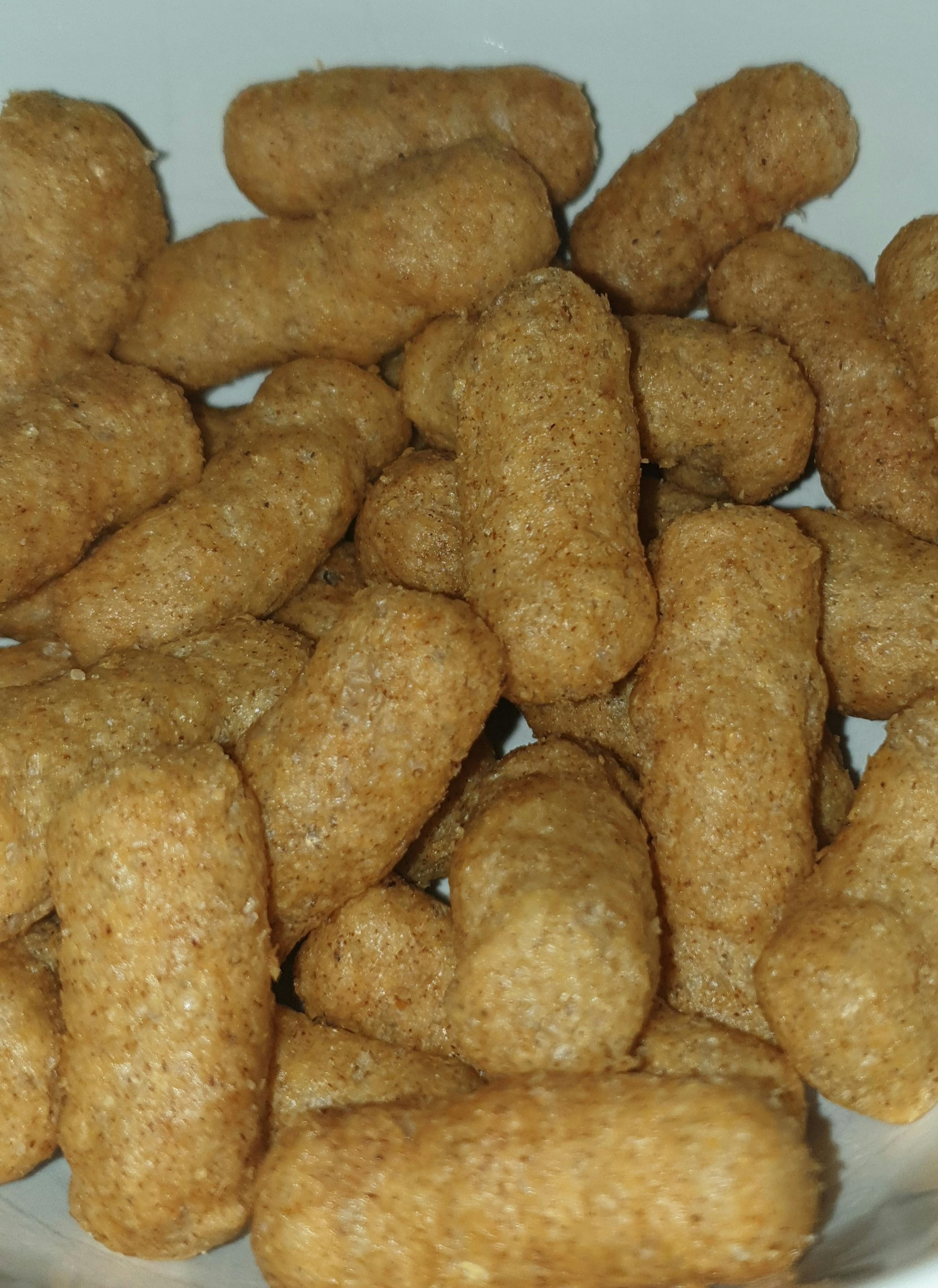 a white plate topped with a pile of cereal sticks