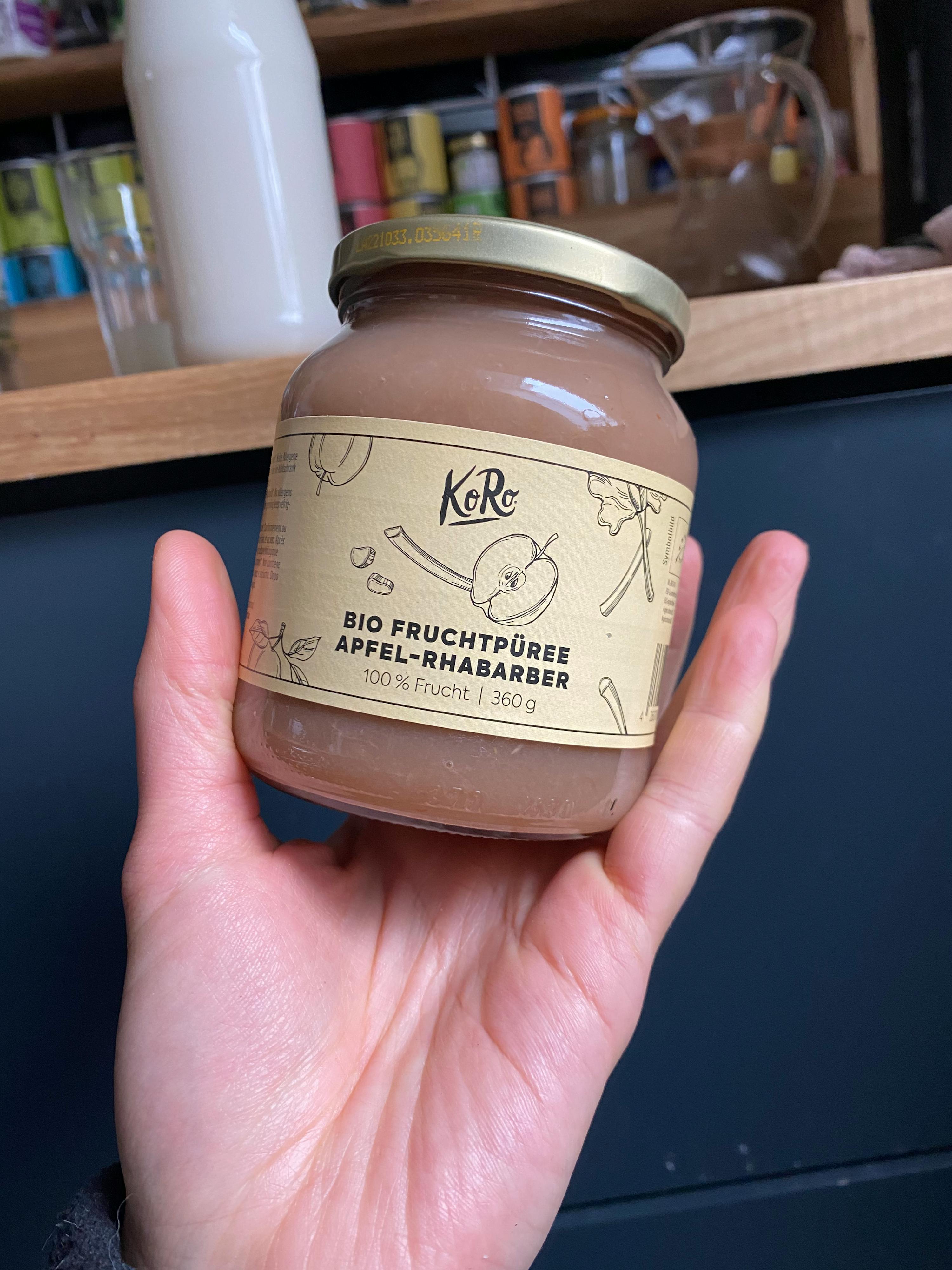 una persona tiene in mano un barattolo di purea di mele