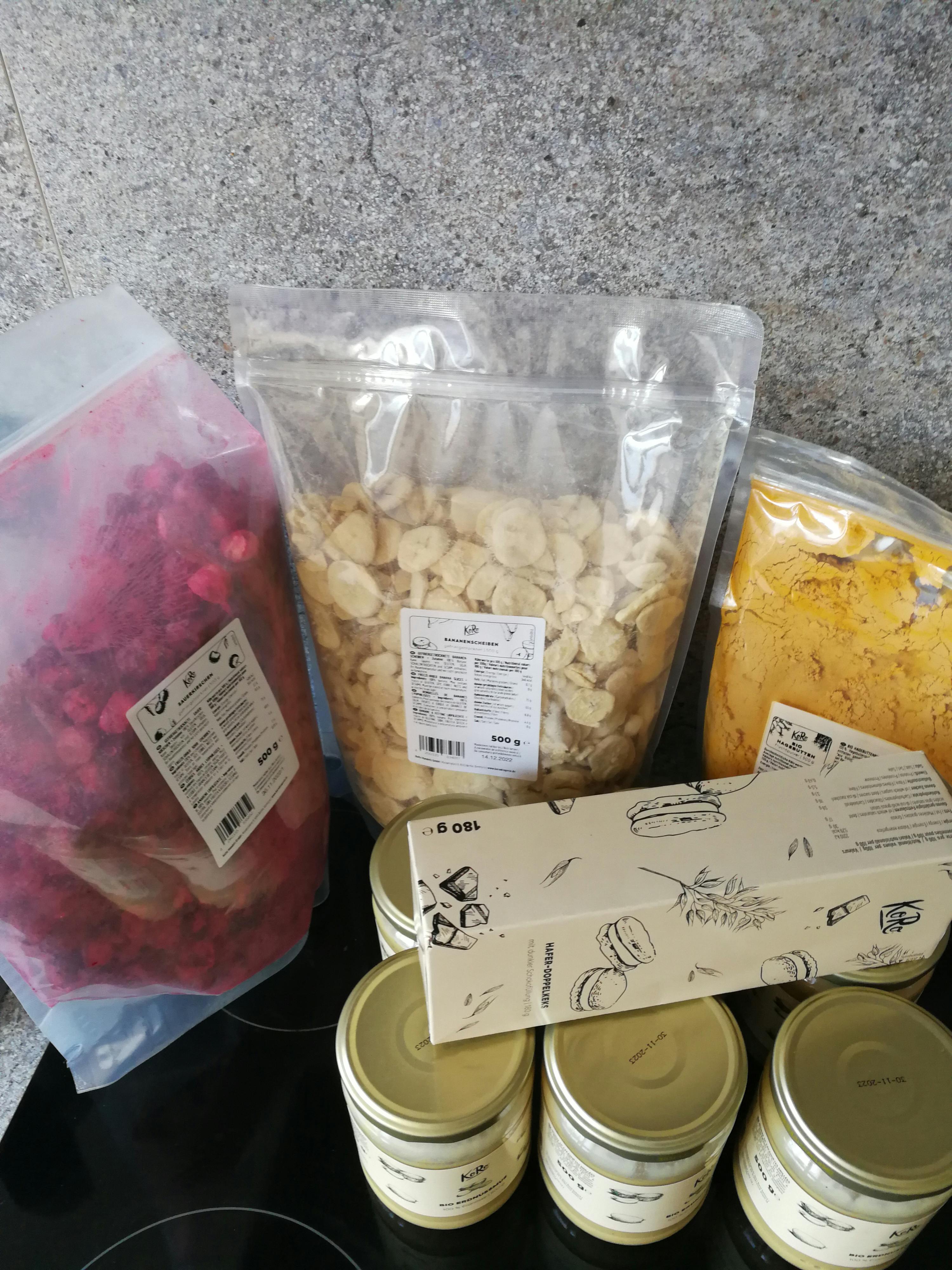 a bag of nuts sits on a stove next to jars