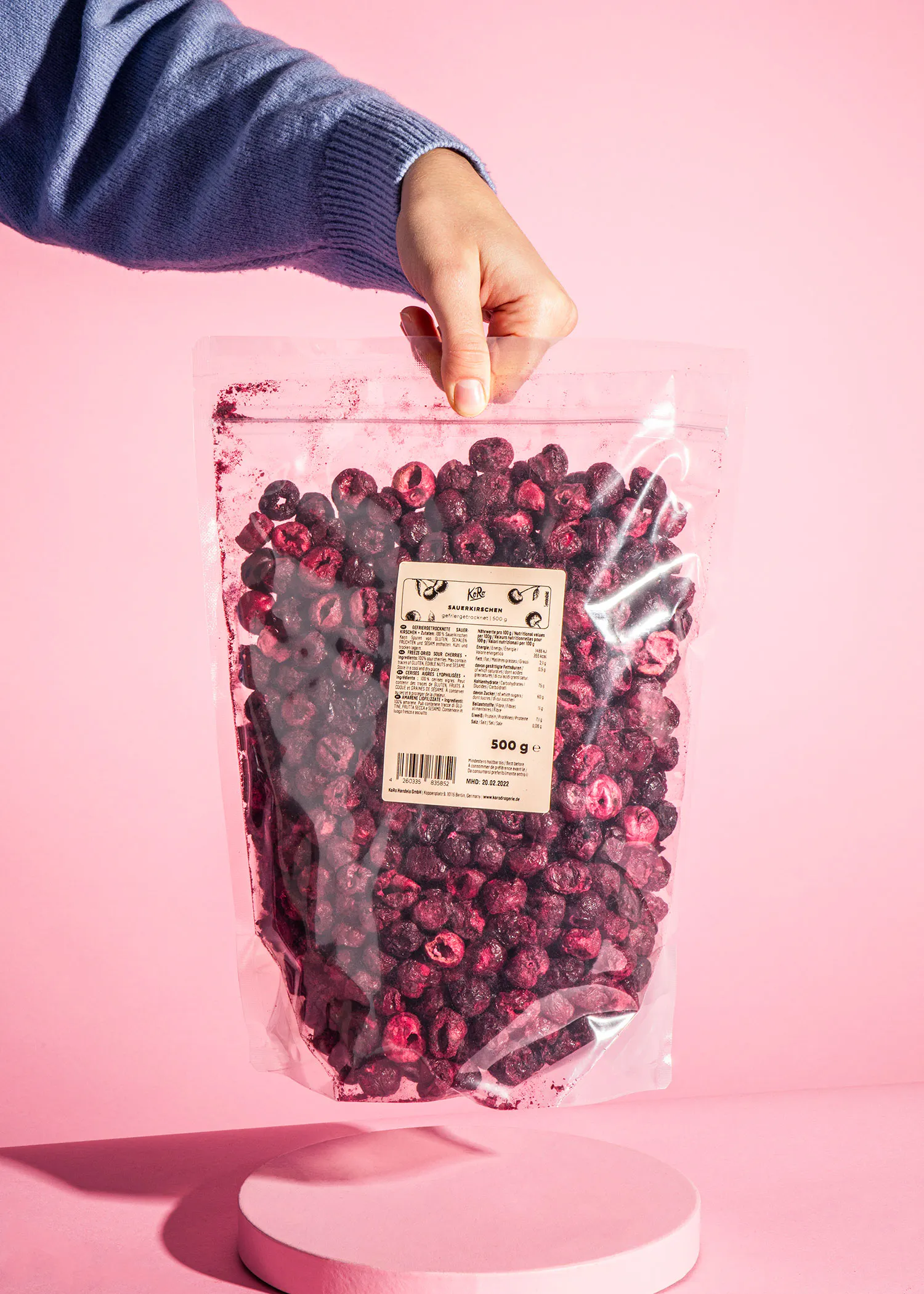 a person is holding a bag of freeze dried blueberries
