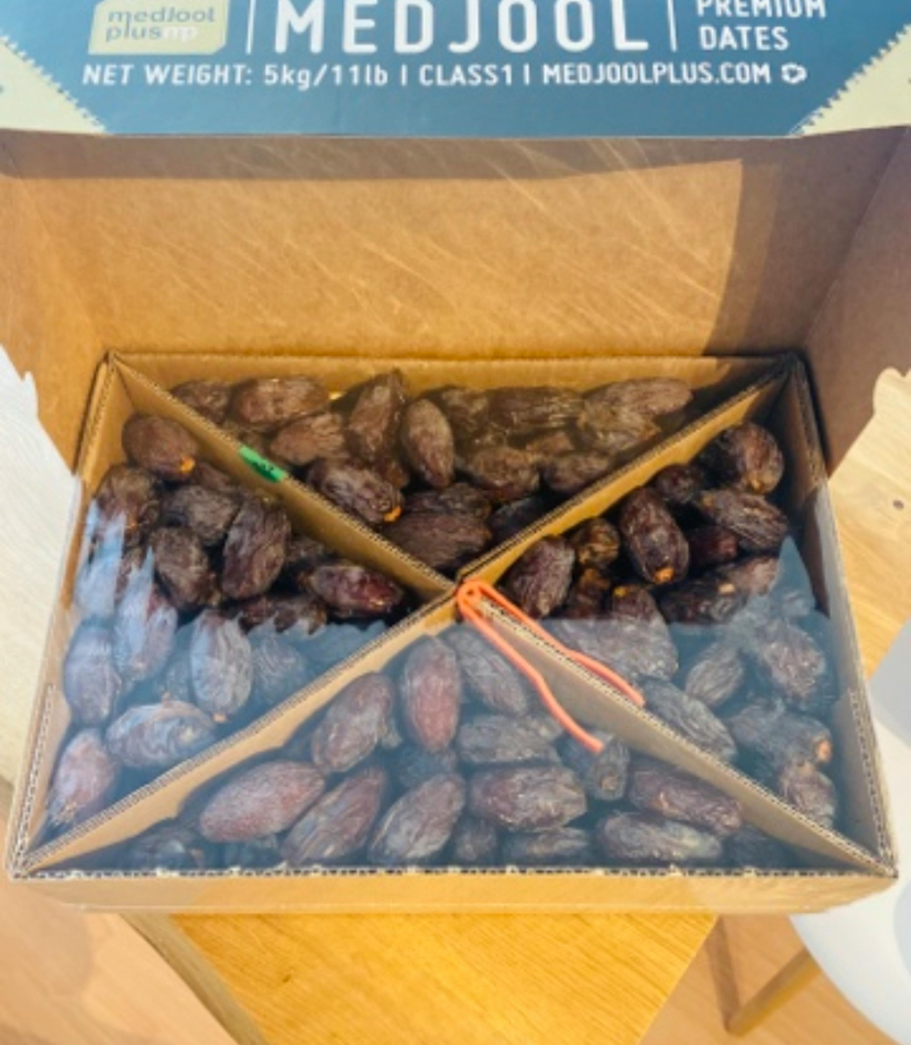 a box of medjool dates sits on a table