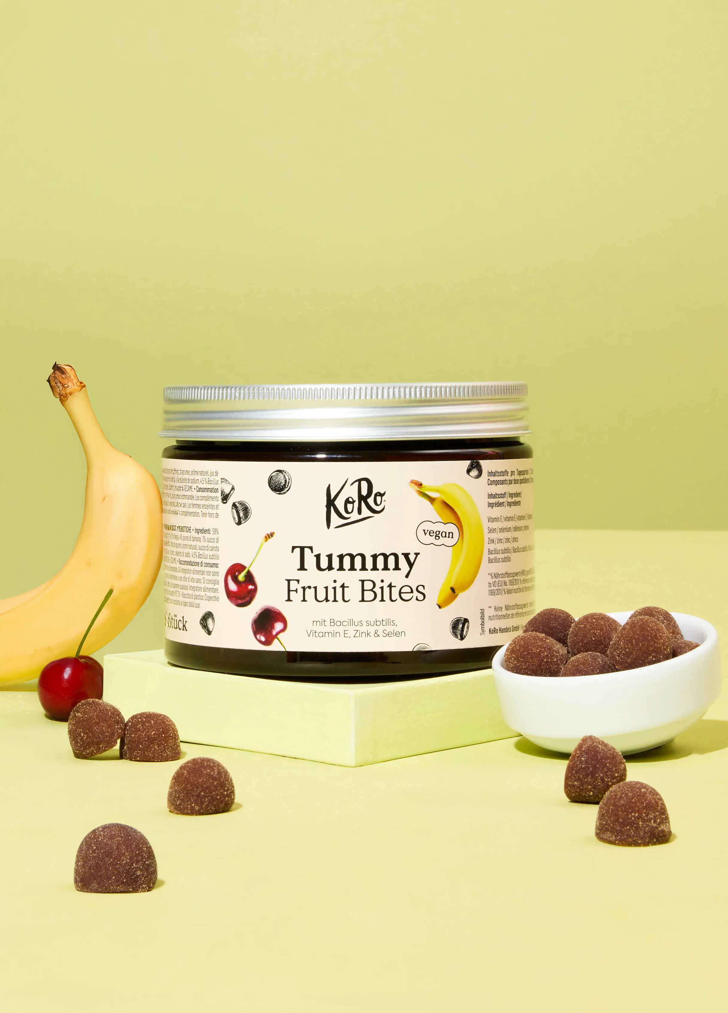 un bocal de bonbons avec une banane et une cerise dessus