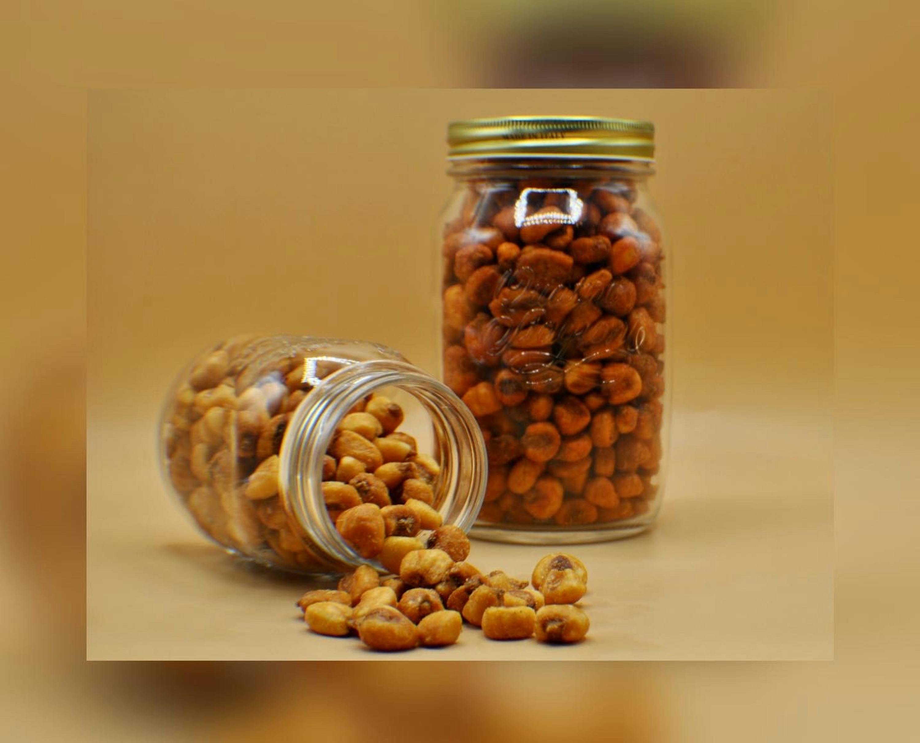 two jars of corn nuts are on a table