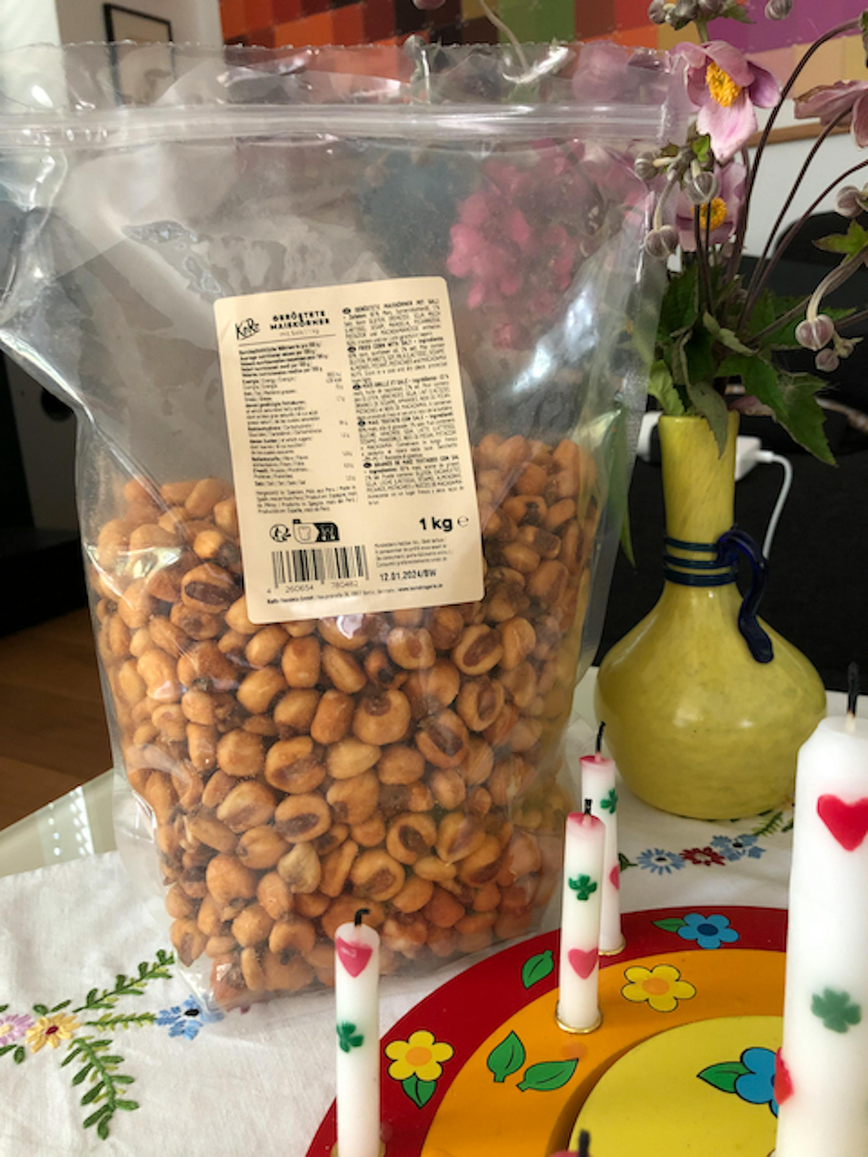 a bag of corn nuts sits on a table next to some candles