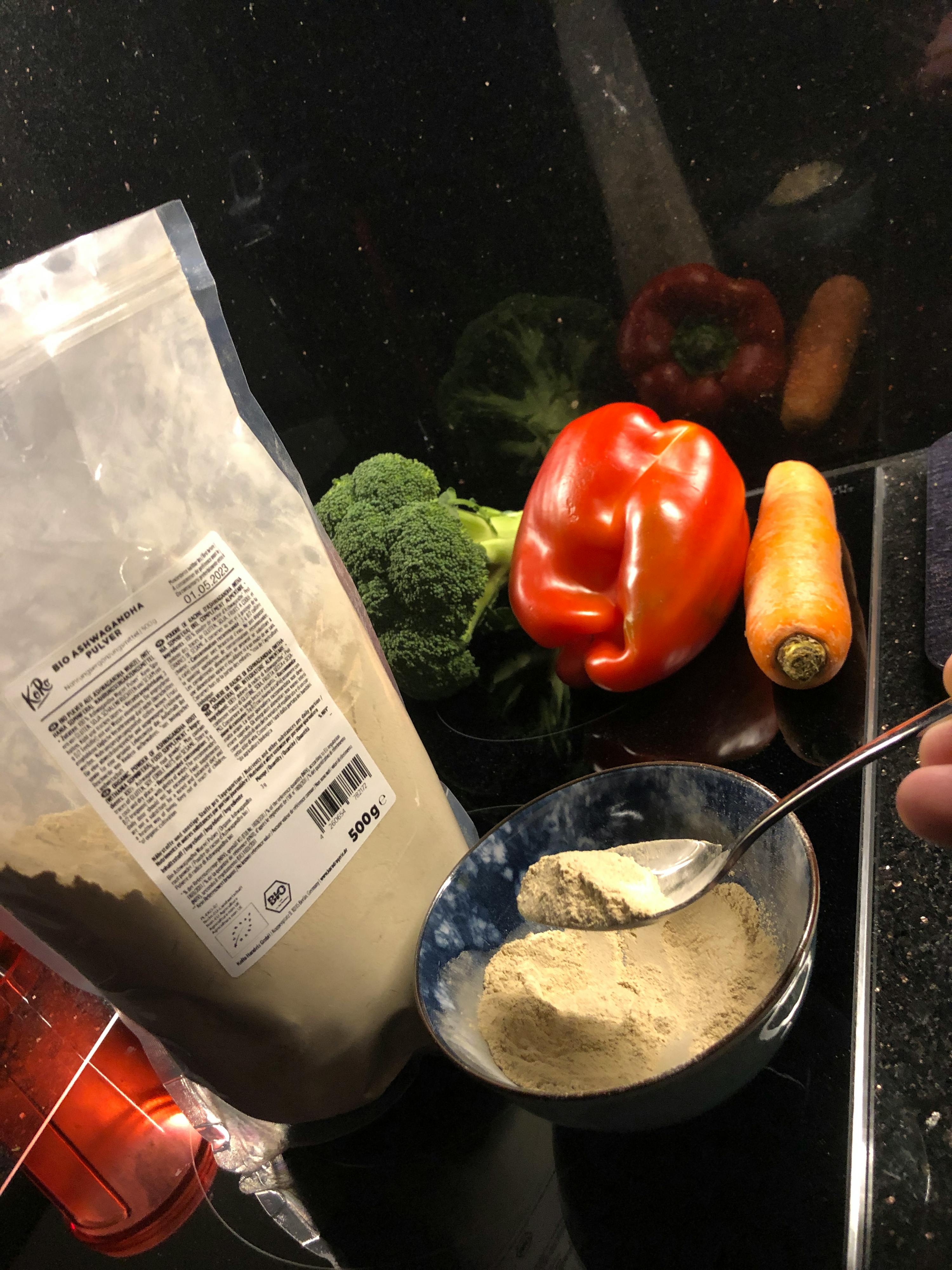 un sacchetto di farina è seduto su un tavolo accanto a verdure e un cucchiaio di farina