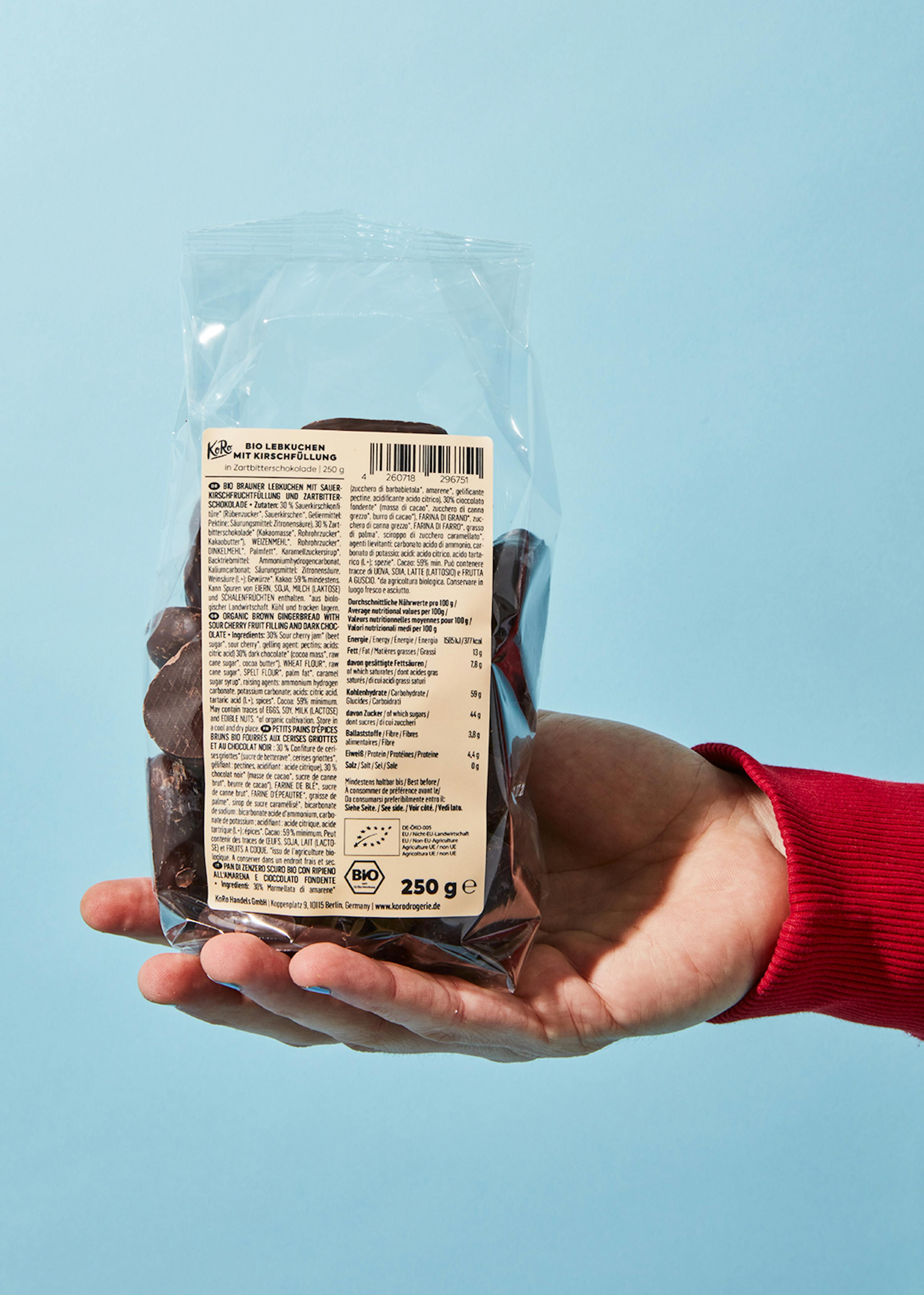 a person is holding a bag of chocolate chips that says bio on it