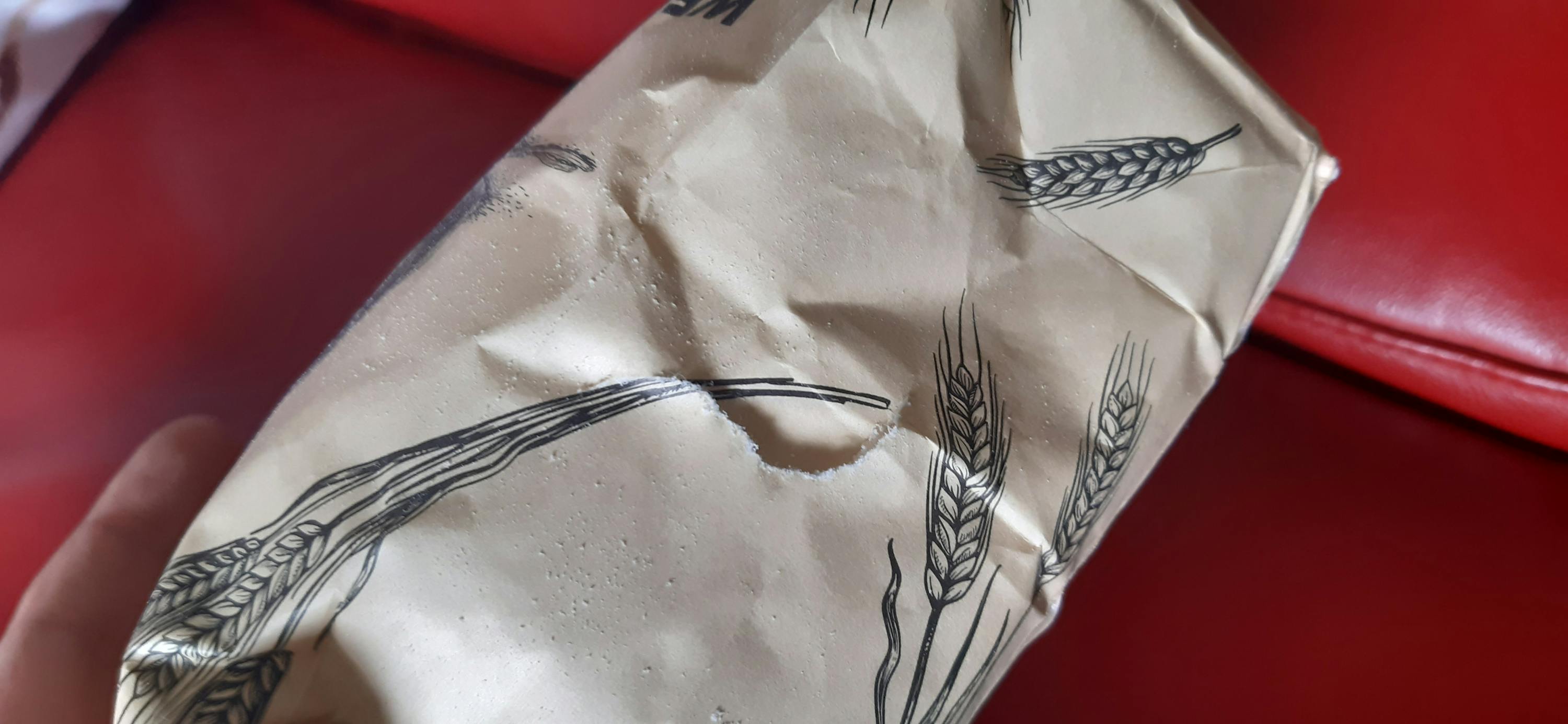 a brown paper bag has a hole in the middle of it