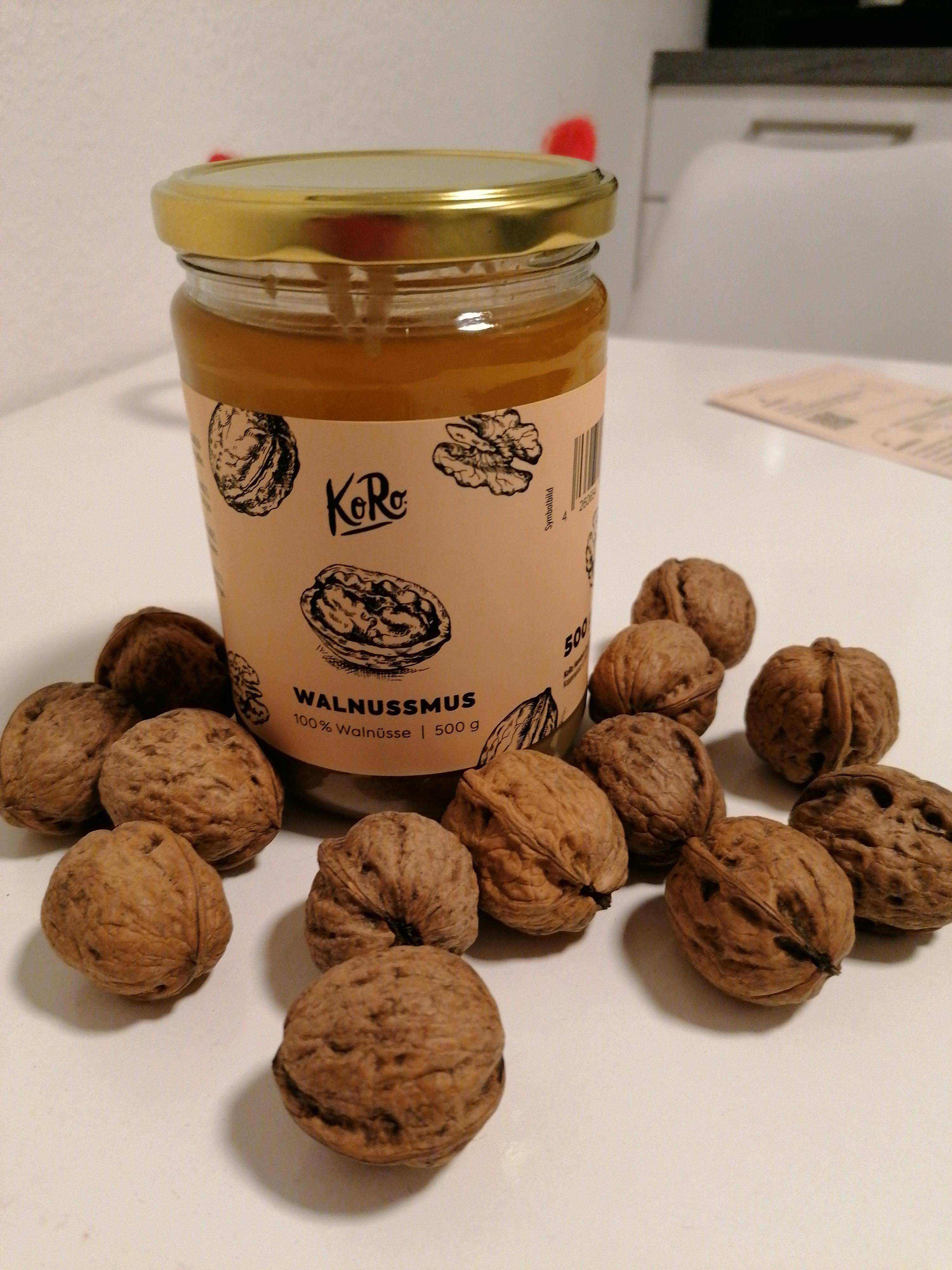 a jar of walnussmus is surrounded by walnuts