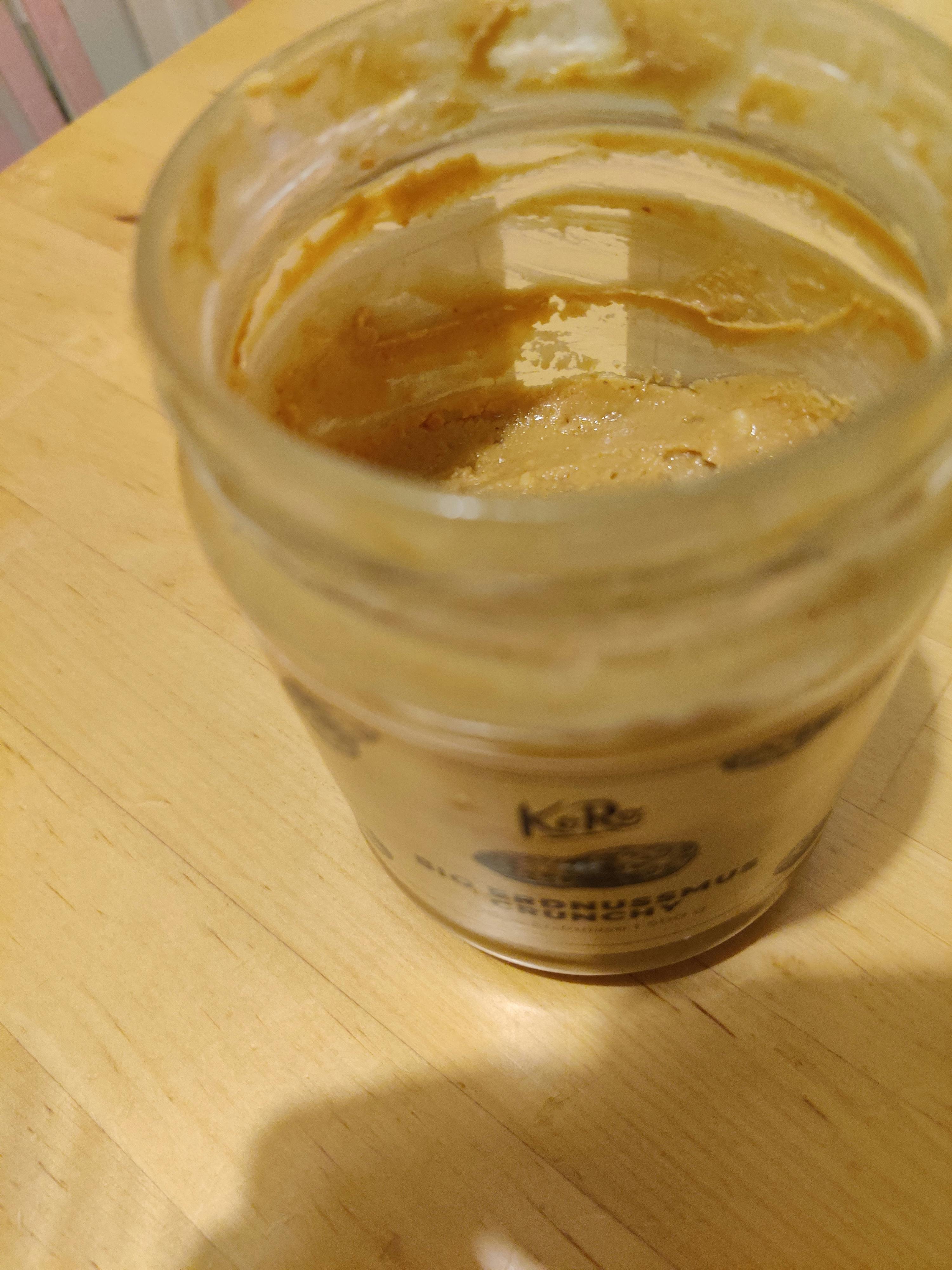 a jar of peanut butter sits on a table