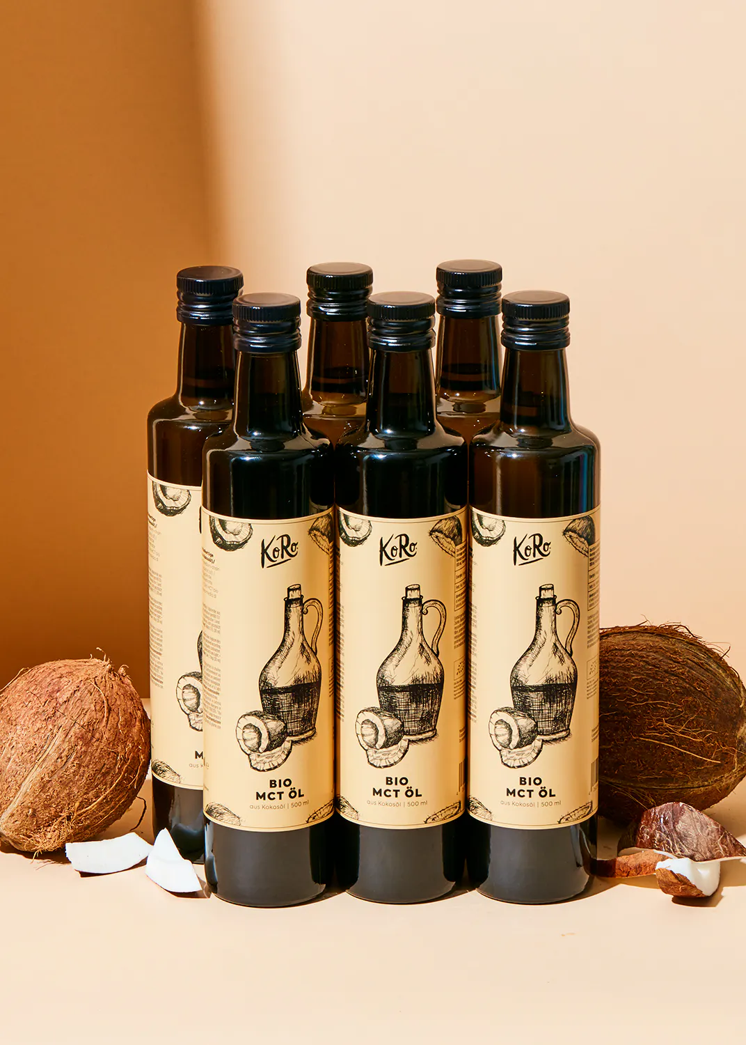 six bottles of bio mct oil with coconuts in the background